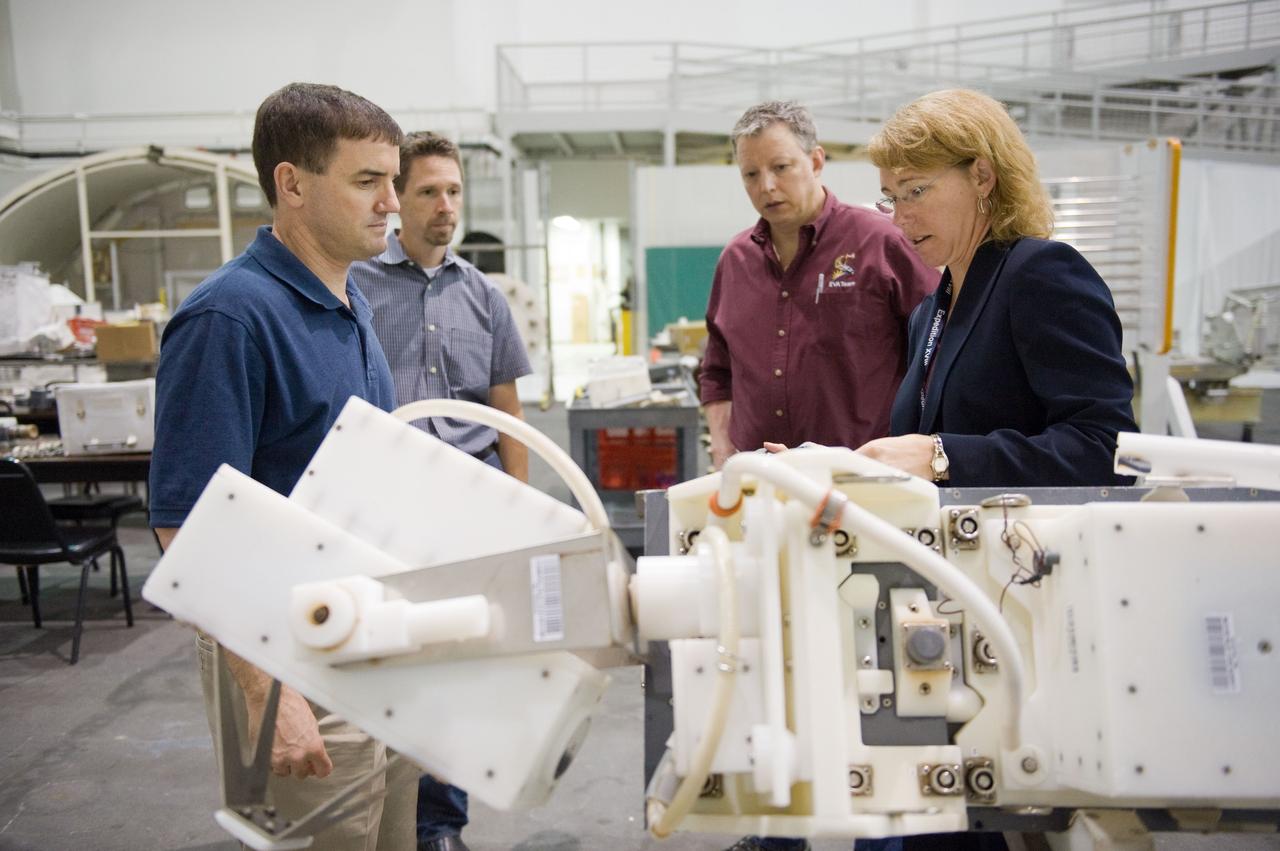 JSC2011-E-029044 (21 March 2011) --- NASA astronauts Rex Walheim (left) and Sandy Magnus, both STS-135 mission specialists, participate in an extravehicular activity (EVA) hardware training session in the Neutral Buoyancy Laboratory (NBL) near NASA's Johnson Space Center. EVA instructors John Ray (right background) and Art Thomason assisted Walheim and Magnus. STS-135 is planned to be the final mission of the space shuttle program. Photo credit: NASA or National Aeronautics and Space Administration