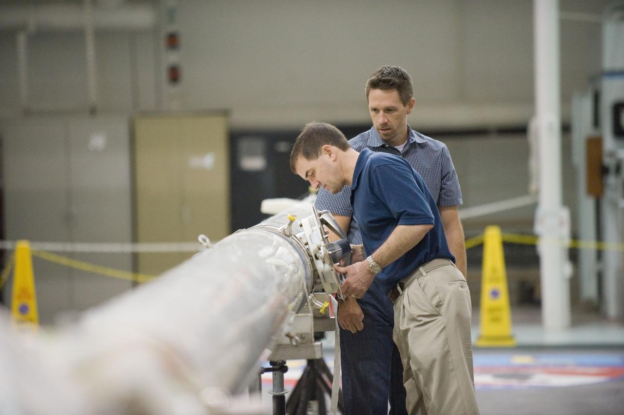 JSC2011-E-029049 (21 March 2011) --- NASA astronaut Rex Walheim (foreground), STS-135 mission specialist, participates in an extravehicular activity (EVA) hardware training session in the Neutral Buoyancy Laboratory (NBL) near NASA's Johnson Space Center. EVA instructor Art Thomason assisted Walheim. STS-135 is planned to be the final mission of the space shuttle program. Photo credit: NASA or National Aeronautics and Space Administration