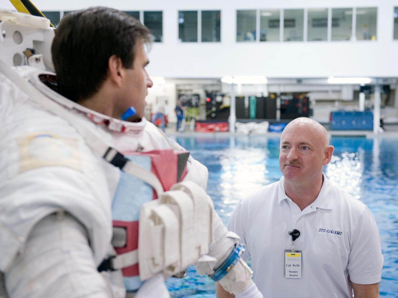 JSC2011-E-029104 (25 March 2011) --- NASA astronauts Mark Kelly (right), STS-134 commander; and Greg Chamitoff, mission specialist, are pictured in the Neutral Buoyancy Laboratory (NBL) at the Sonny Carter Training Facility near NASA's Johnson Space Center. Chamitoff, wearing a training version of his Extravehicular Mobility Unit (EMU) spacesuit, is preparing for a spacewalk training session in the waters of the NBL. Photo credit: NASA or National Aeronautics and Space Administration