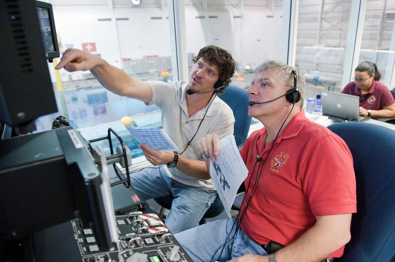 JSC2011-E-029130 (25 March 2011) --- NASA astronaut Greg H. Johnson (foreground), STS-134 pilot, participates in a training session in the simulation control area in the Neutral Buoyancy Laboratory (NBL) at the Sonny Carter Training Facility near NASA's Johnson Space Center. Photo credit: NASA or National Aeronautics and Space Administration