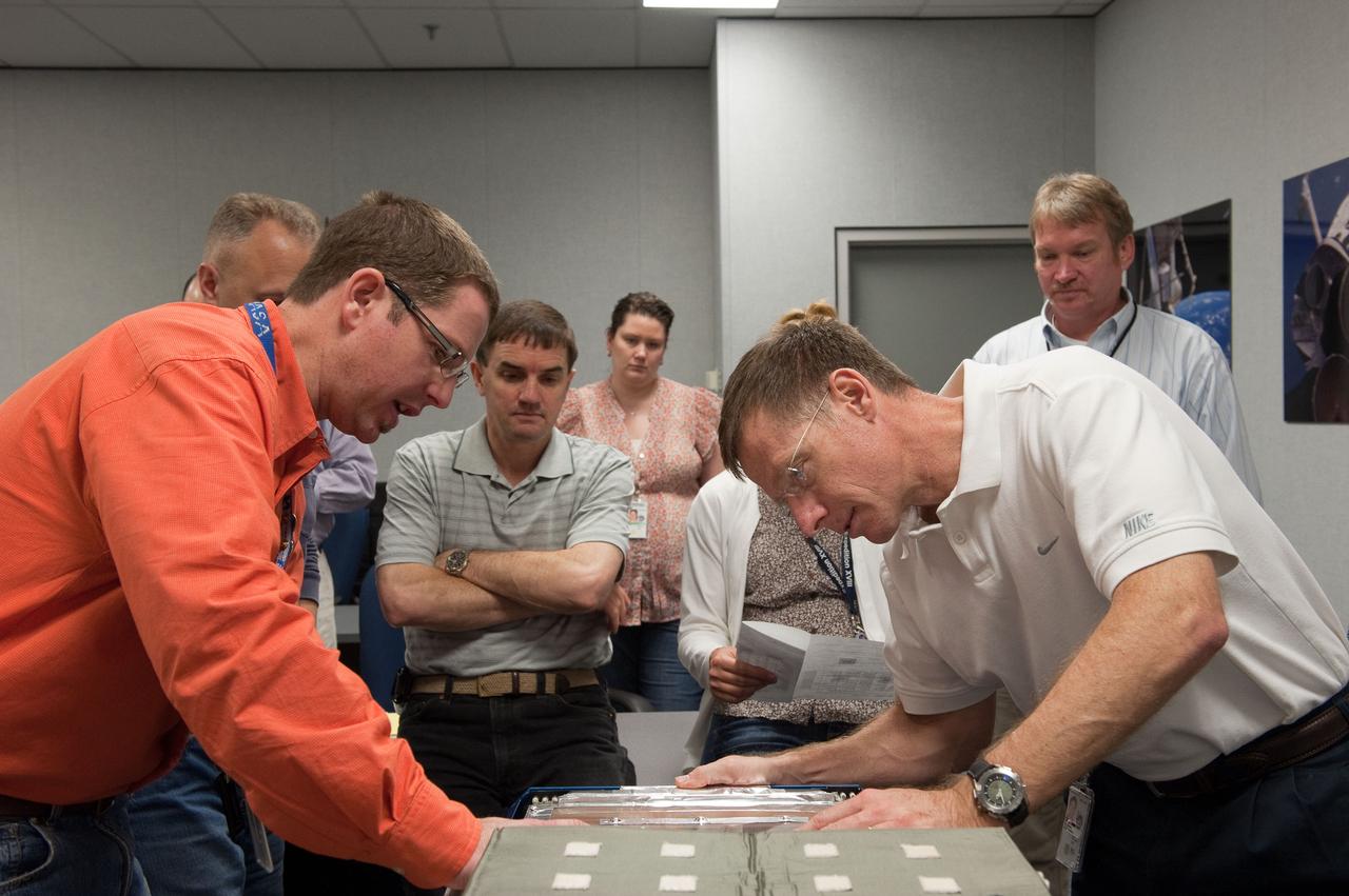 JSC2011-E-029136 (25 March 2011) --- STS-135 crew members participate in an Animal Enclosure Module (AEM) training session in the Jake Garn Simulation and Training Facility at NASA's Johnson Space Center. Pictured on the right (foreground) is NASA astronaut Chris Ferguson, commander. Pictured in the background (from the left) are astronauts Doug Hurley (mostly obscured), pilot; Rex Walheim and Sandy Magnus (partially obscured), both mission specialists. STS-135 is planned to be the final mission of the space shuttle program. Photo credit: NASA or National Aeronautics and Space Administration