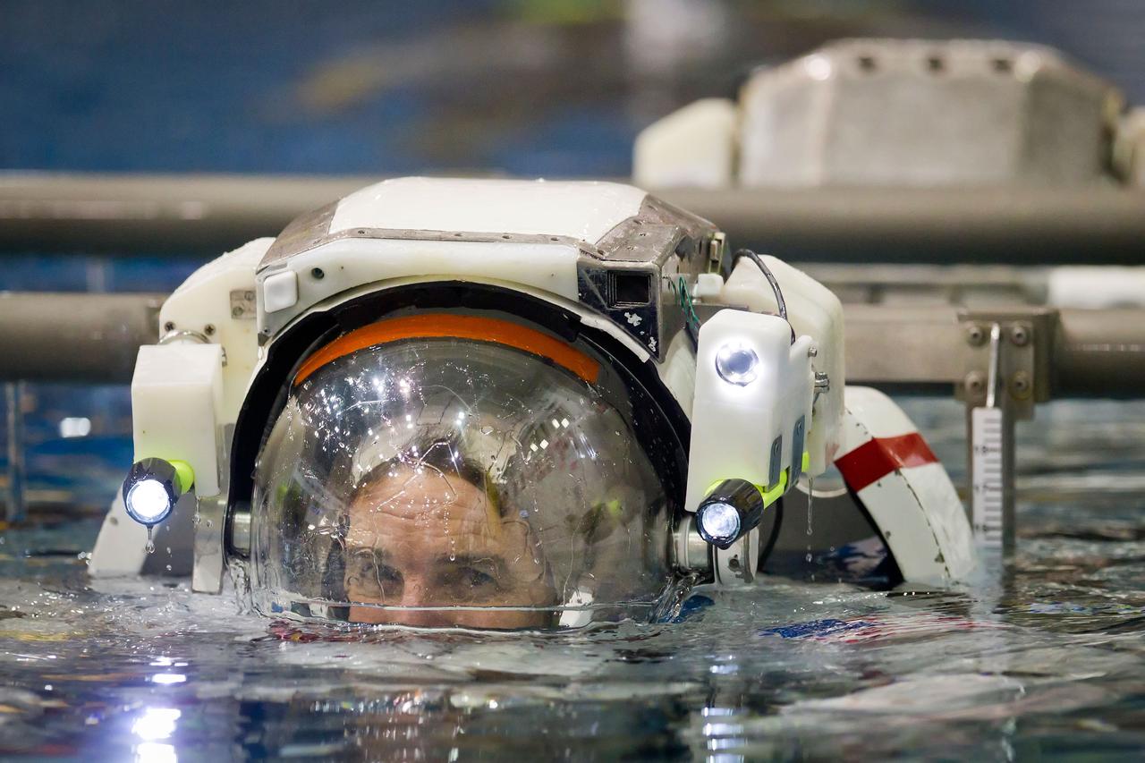 NASA astronaut Rex Walheim is lowered into the water to train for spacewalk  in the Neutral Buoyancy Laboratory (NBL) on Tuesday, March 22, 2011, in Houston.  ( NASA Photo / Houston Chronicle, Smiley N. Pool )