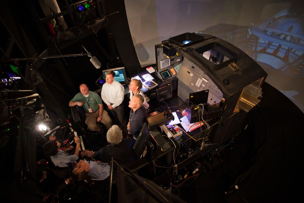 JSC2011-E-040267 (23 March 2011) --- NASA astronauts Chris Ferguson, STS-135 commander; Sandy Magnus, mission specialist; and Doug Hurley, pilot, are interviewed by a crowd of media in the Systems Engineering Simulator at NASA?s Johnson Space Center on March 23, 2011. Photo credit: NASA Photo/Houston Chronicle, Smiley N. Pool