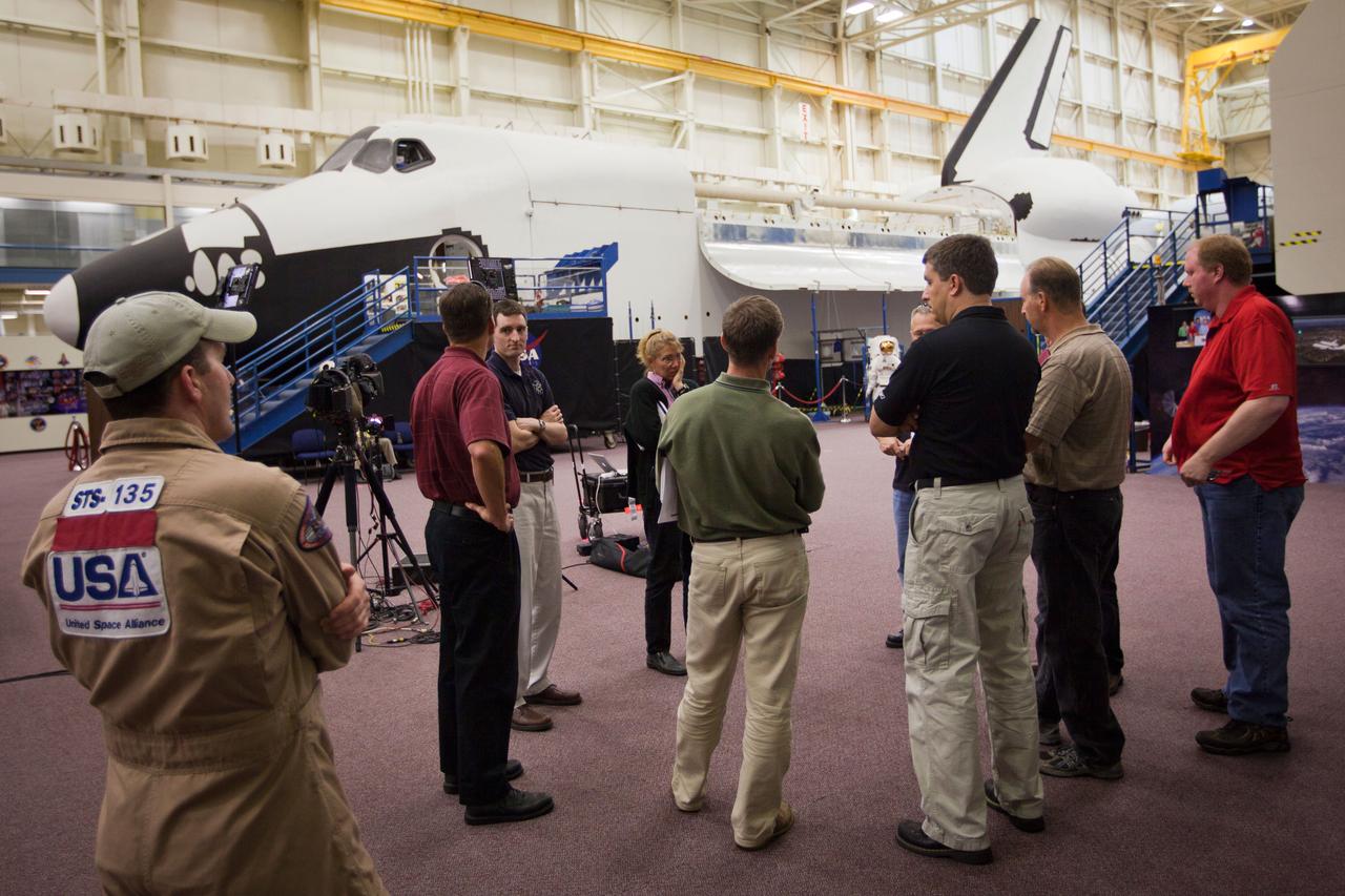 JSC2011-E-040269 (24 March 2011) --- The crew members of STS-135 are briefed by trainers before they participate in a post-insertion training session in the Full-Fuselage Trainer in the Space Vehicle Mock-up Facility at NASA's Johnson Space Center in Houston March 24, 2011. Photo credit: NASA Photo/Houston Chronicle, Smiley N. Pool