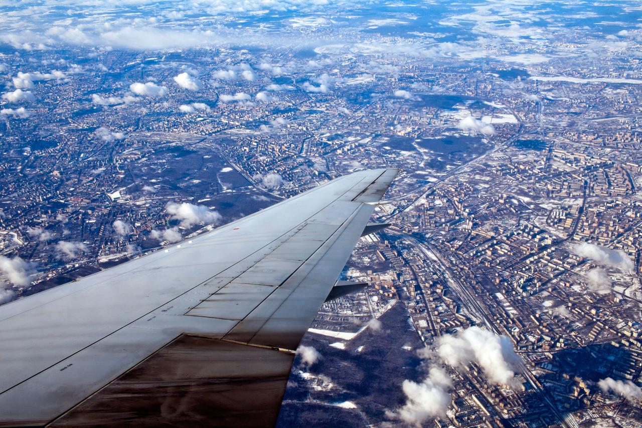 JSC2011-E-040290 (27 March 2011) --- Moscow stretches out in all directions as seen from a commercial flight carrying NASA astronauts Doug Hurley, STS-135 pilot, and Rex Walheim, mission specialist, to Moscow, Russia on March 27, 2011. The crew of the final shuttle mission traveled to Moscow to be fitted for Russian Sokol spacesuits which would be required in the event of an emergency. If the shuttle is unable to return to Earth, the crew will remain on the International Space Station and return on a staggered basis in the course of a year on scheduled Soyuz flights to the station. Photo credit: NASA Photo/Houston Chronicle, Smiley N. Pool