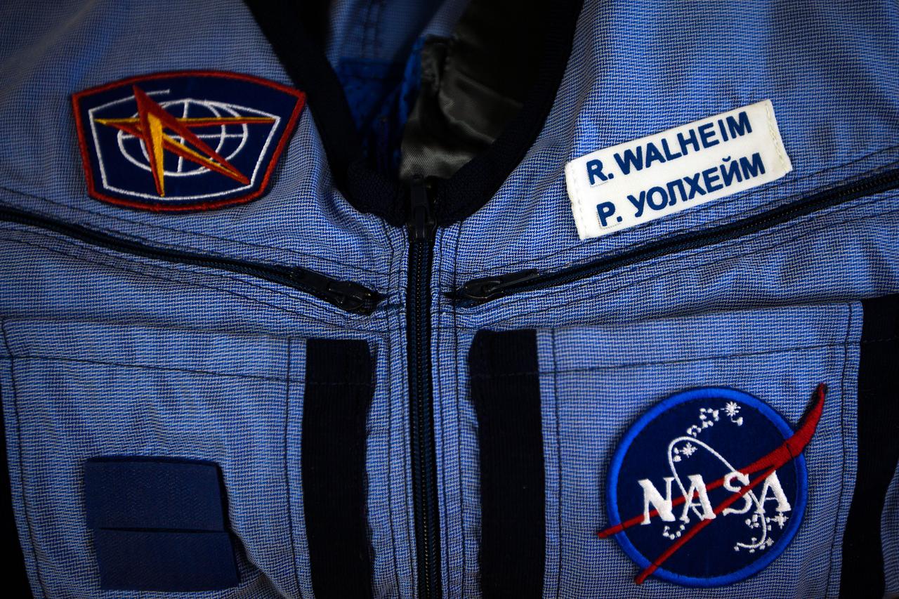 JSC2011-E-040302 (28 March 2011) --- NASA astronaut Rex Walheim's name is seen in both English and Russian on a "Penguin" suit during a suit fit check at the Zvezda facility in Moscow on March 28, 2011. The crew of the final shuttle mission traveled to Moscow for a suit fit check of their Russian Sokol suits which would be required in the event of an emergency. Photo credit: NASA Photo/Houston Chronicle, Smiley N. Pool