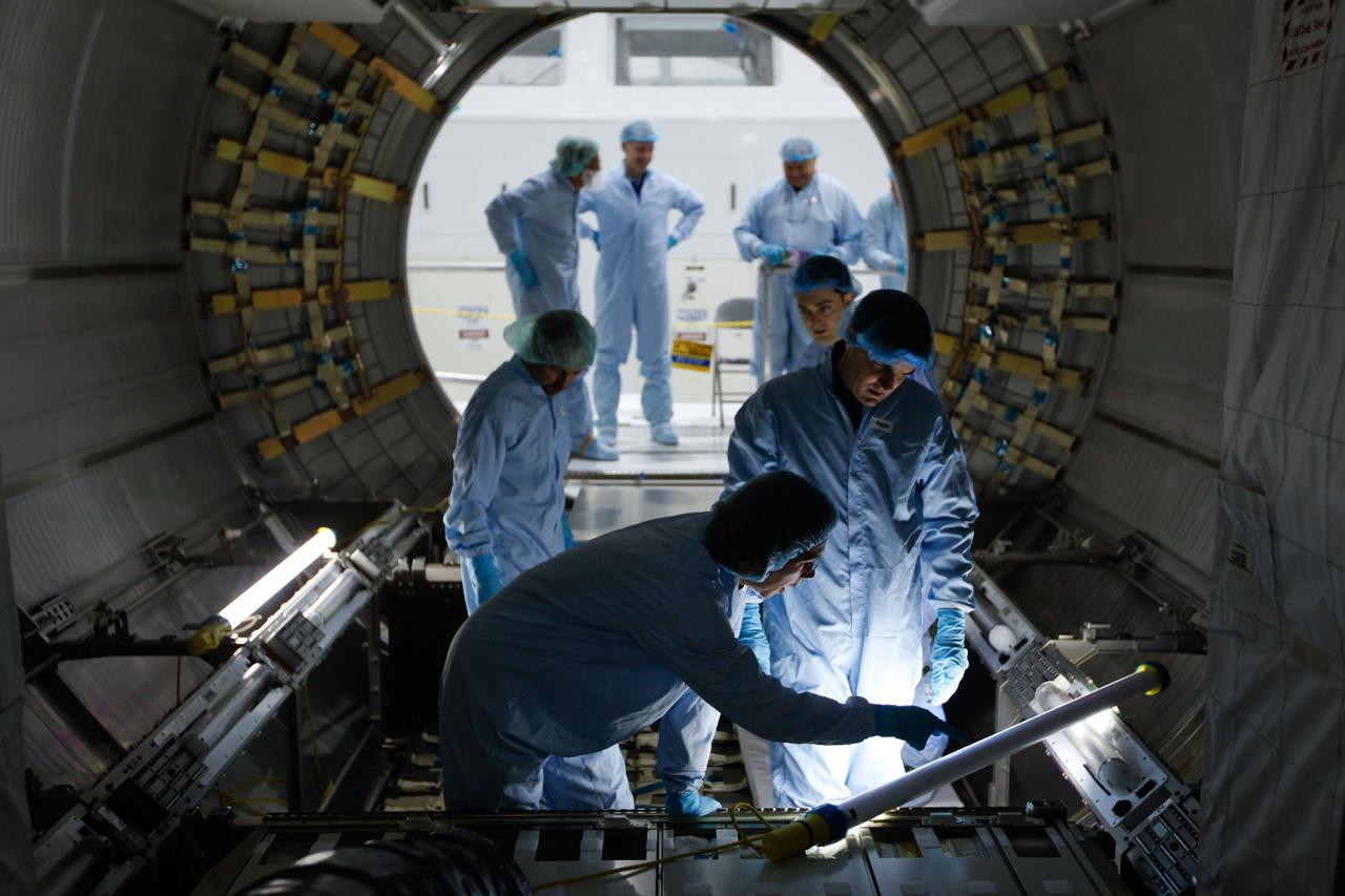 JSC2011-E-040338 (7 April 2011) --- NASA astronauts Sandy Magnus and Rex Walheim, both STS-135 mission specialists, work in the Multi-Purpose Logistics Module in the Space Station Processing Facility during the STS-135 Crew Equipment Interface Test (CEIT) at the Kennedy Space Center in Florida on April 7, 2011.   Photo credit: NASA Photo/Houston Chronicle, Smiley N. Pool