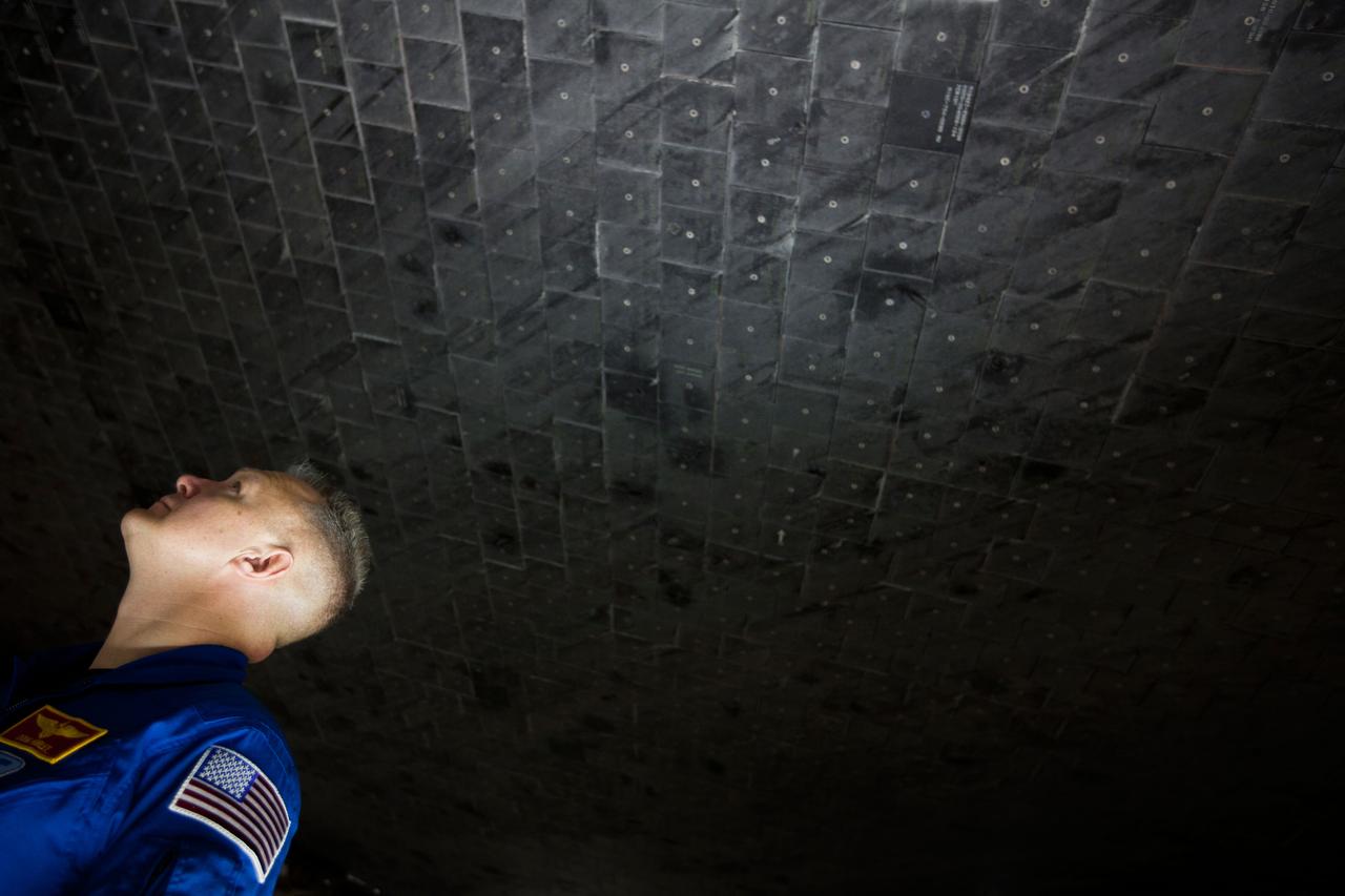 JSC2011-E-040343 (7 April 2011) --- NASA astronaut Doug Hurley, STS-135 pilot, looks at the thermal protection system on the underside of the space shuttle Atlantis during the mission's Crew Equipment Interface Test (CEIT) at the Kennedy Space Center in Florida on April 7, 2011.  Photo credit:  NASA Photo/Houston Chronicle, Smiley N. Pool