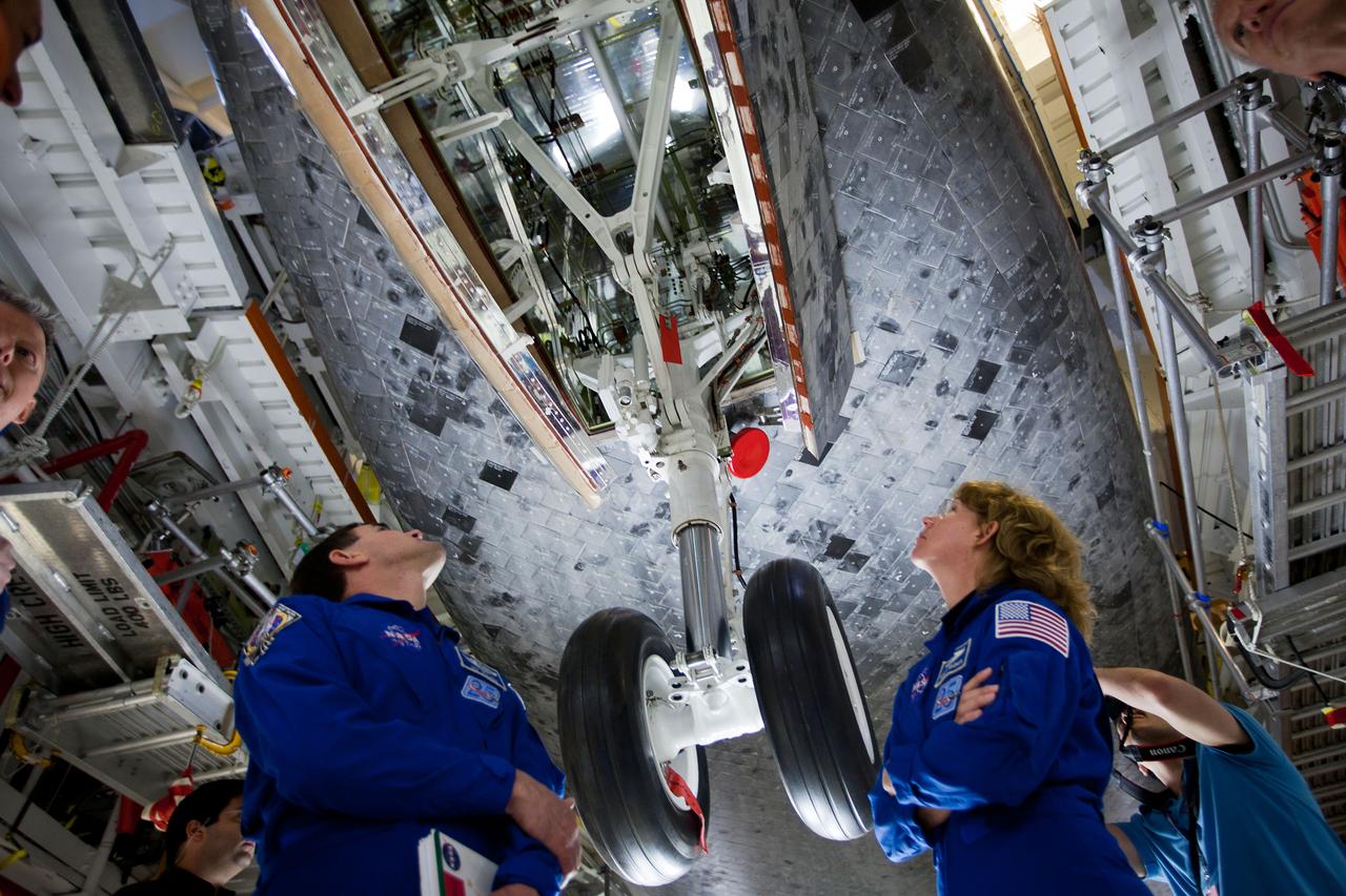 JSC2011-E-040345 (7 April 2011) --- NASA astronauts Rex Walheim and Sandy Magnus, STS-135 mission specialists, inspect the front landing gear of the space shuttle Atlantis during the STS-135 Crew Equipment Interface Test (CEIT) at NASA?s Kennedy Space Center, Florida on April 7, 2011.  Photo credit: NASA Photo/Houston Chronicle, Smiley N. Pool