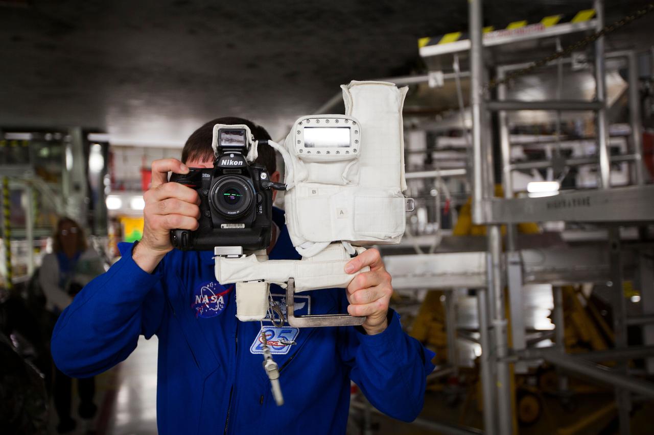 JSC2011-E-040349 (7 April 2011) --- NASA astronaut Rex Walheim, STS-135 mission specialist, familiarizes himself with a camera he will use in space during the STS-135 Crew Equipment Interface Test (CEIT) in the Orbiter Processing Facility at NASA?s Kennedy Space Center, Florida on April 7, 2011. Photo credit: NASA Photo/Houston Chronicle, Smiley N. Pool