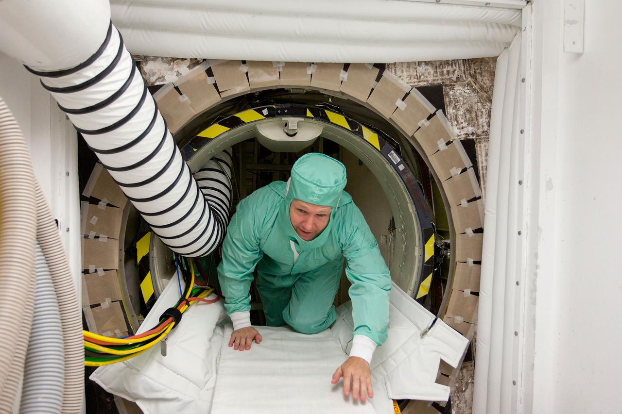 JSC2011-E-040358 (7 April 2011) --- NASA astronaut Doug Hurley, STS-135 pilot, exits the hatch of the space shuttle Atlantis during the STS-135 Crew Equipment Interface Test (CEIT) in the Orbiter Processing Facility at NASA?s Kennedy Space Center, Florida on April 7, 2011. Photo credit: NASA Photo/Houston Chronicle, Smiley N. Pool