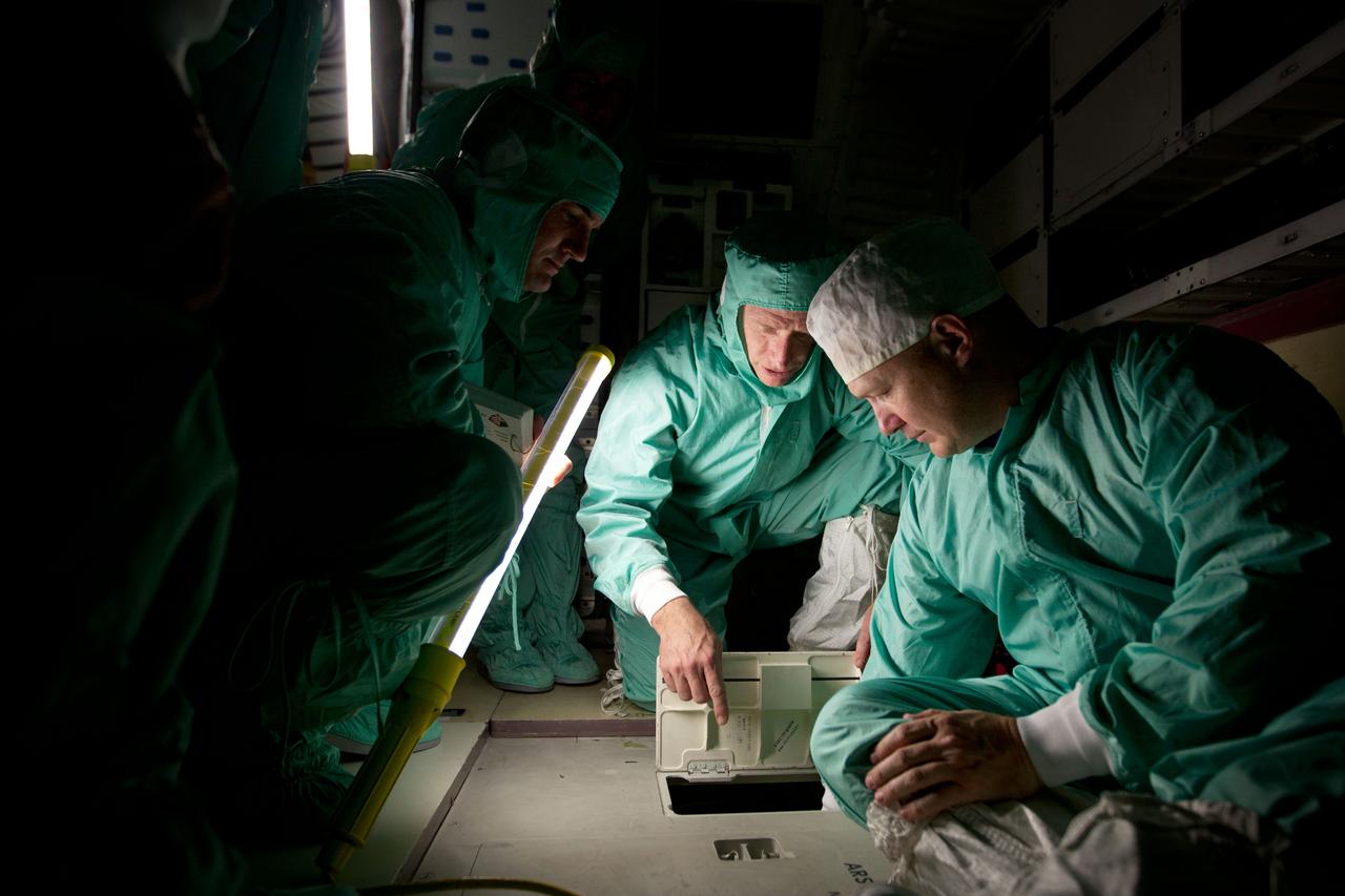 JSC2011-E-040371 (8 April 2011) --- NASA astronauts, from left, Rex Walheim, Chris Ferguson and Doug Hurley inspect the middeck of the space shuttle Atlantis during the STS-135 Crew Equipment Interface Test (CEIT) in the Orbiter Processing Facility at the Kennedy Space Center in Florida,  April 8, 2011.  Photo credit:  NASA Photo/Houston Chronicle, Smiley N. Pool