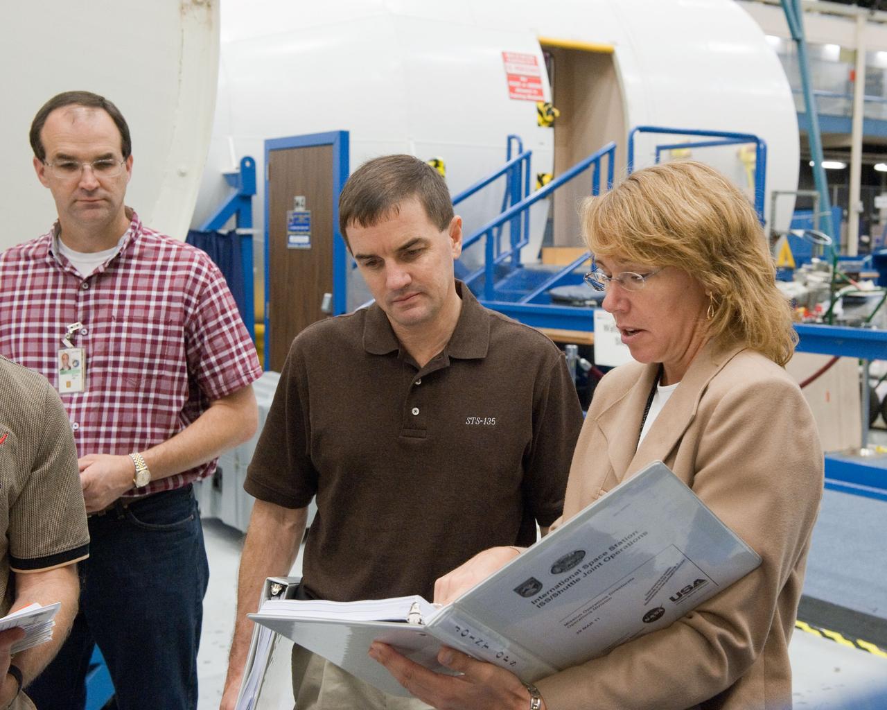 JSC2011-E-043696 (29 April 2011) --- NASA astronauts Rex Walheim (center) and Sandy Magnus, both STS-135 mission specialists, participate in an ingress/egress timeline training session in the Space Vehicle Mock-up Facility at NASA's Johnson Space Center. Photo credit: NASA