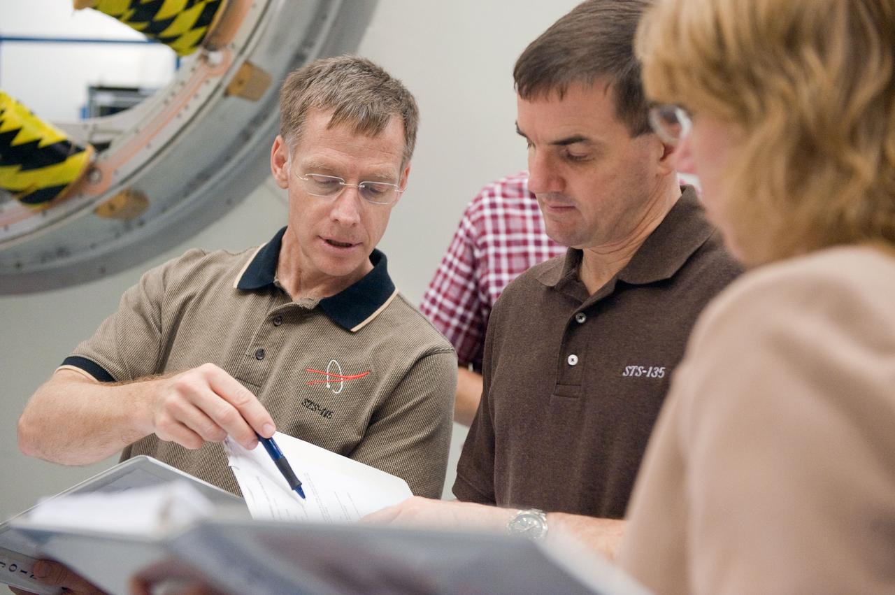 JSC2011-E-043699 (29 April 2011) --- NASA astronaut Chris Ferguson (left), STS-135 commander; along with astronauts Rex Walheim and Sandy Magnus, both mission specialists, participate in an ingress/egress timeline training session in the Space Vehicle Mock-up Facility at NASA's Johnson Space Center. Photo credit: NASA