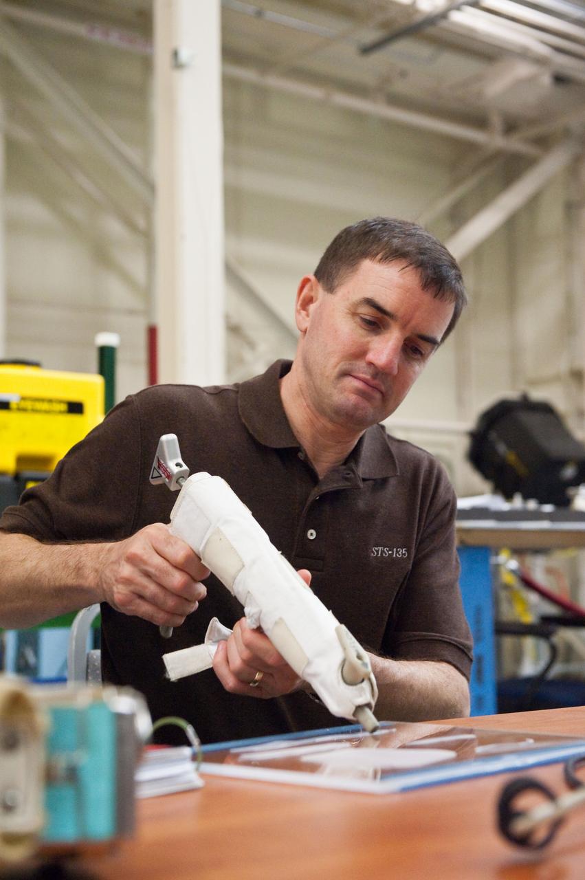 JSC2011-E-043875 (29 April 2011) --- NASA astronaut Rex Walheim, STS-135 mission specialist, participates in an EVA Thermal Protection System (TPS) overview training session in the TPS/Precision Air Bearing Facility in the Space Vehicle Mock-up Facility at NASA's Johnson Space Center. Photo credit: NASA