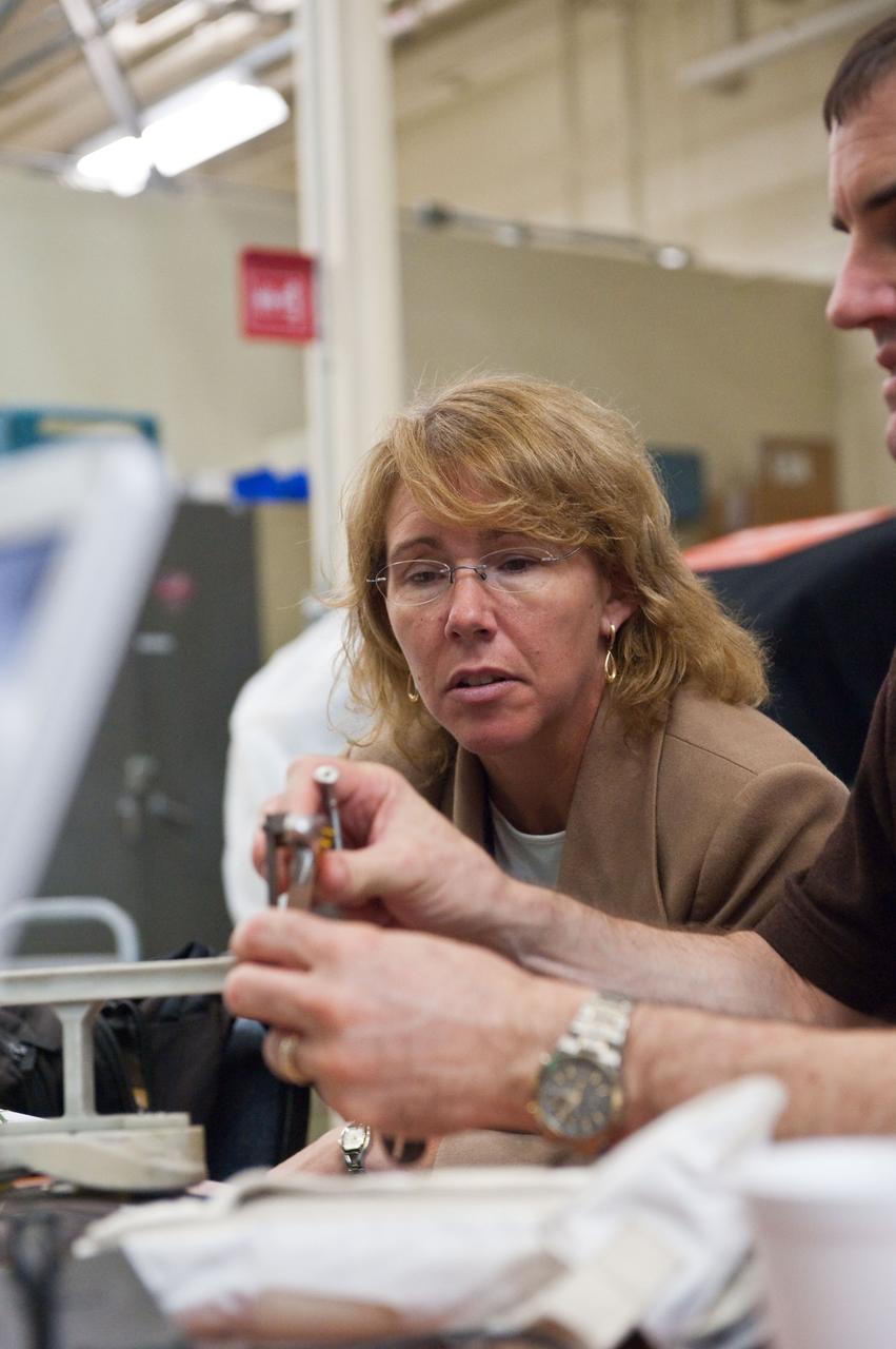 JSC2011-E-043876 (29 April 2011) --- NASA astronauts Sandy Magnus and Rex Walheim (mostly out of frame at right), both STS-135 mission specialists, participate in an EVA Thermal Protection System (TPS) overview training session in the TPS/Precision Air Bearing Facility in the Space Vehicle Mock-up Facility at NASA's Johnson Space Center. Photo credit: NASA