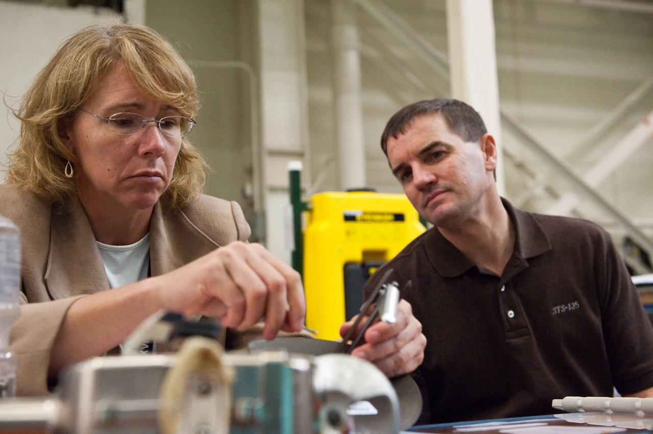 JSC2011-E-043878 (29 April 2011) --- NASA astronauts Sandy Magnus and Rex Walheim, both STS-135 mission specialists, participate in an EVA Thermal Protection System (TPS) overview training session in the TPS/ Precision Air Bearing Facility in the Space Vehicle Mock-up Facility at NASA's Johnson Space Center. Photo credit: NASA