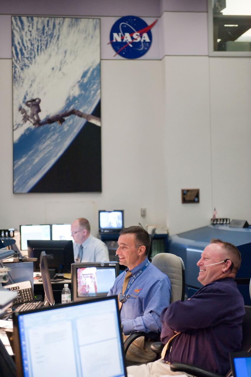 JSC2011-E-044245 (16 May 2011) --- NASA astronauts Barry Wilmore (foreground) and Lee Archambault, both STS-134 spacecraft communicators (CAPCOM), are pictured at their console in the space shuttle flight control room in the Mission Control Center at NASA's Johnson Space Center during launch countdown activities a few hundred miles away in Florida, site of space shuttle Endeavour's STS-134 launch. Liftoff was at 8:56 a.m. (EDT) on May 16, 2011, from Launch Pad 39A at NASA's Kennedy Space Center. Photo credit: NASA
