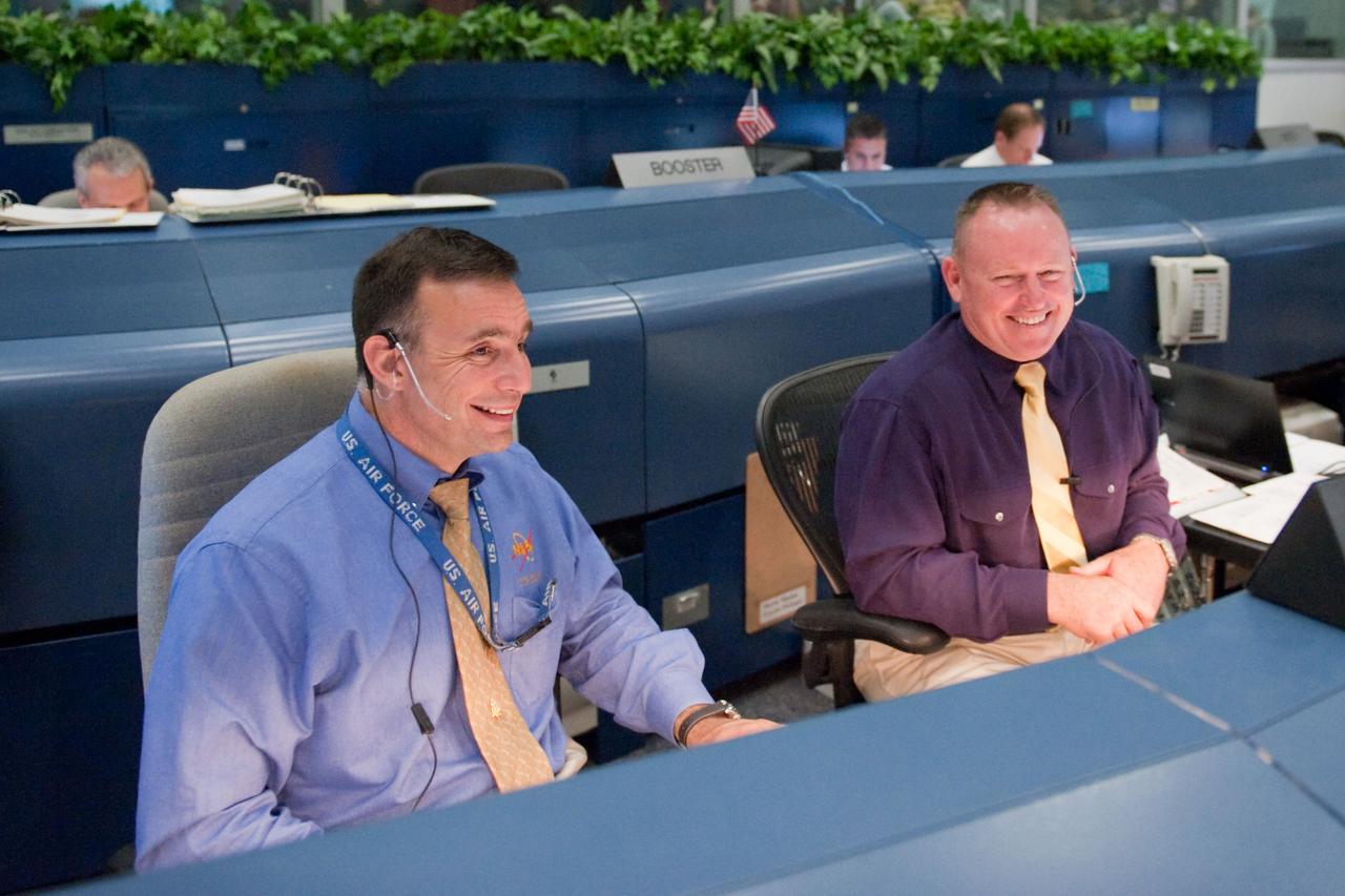 JSC2011-E-044249 (16 May 2011) --- NASA astronauts Lee Archambault (left) and Barry Wilmore, both STS-134 spacecraft communicators (CAPCOM), are pictured at their console in the space shuttle flight control room in the Mission Control Center at NASA's Johnson Space Center during launch countdown activities a few hundred miles away in Florida, site of space shuttle Endeavour's STS-134 launch. Liftoff was at 8:56 a.m. (EDT) on May 16, 2011, from Launch Pad 39A at NASA's Kennedy Space Center. Photo credit: NASA
