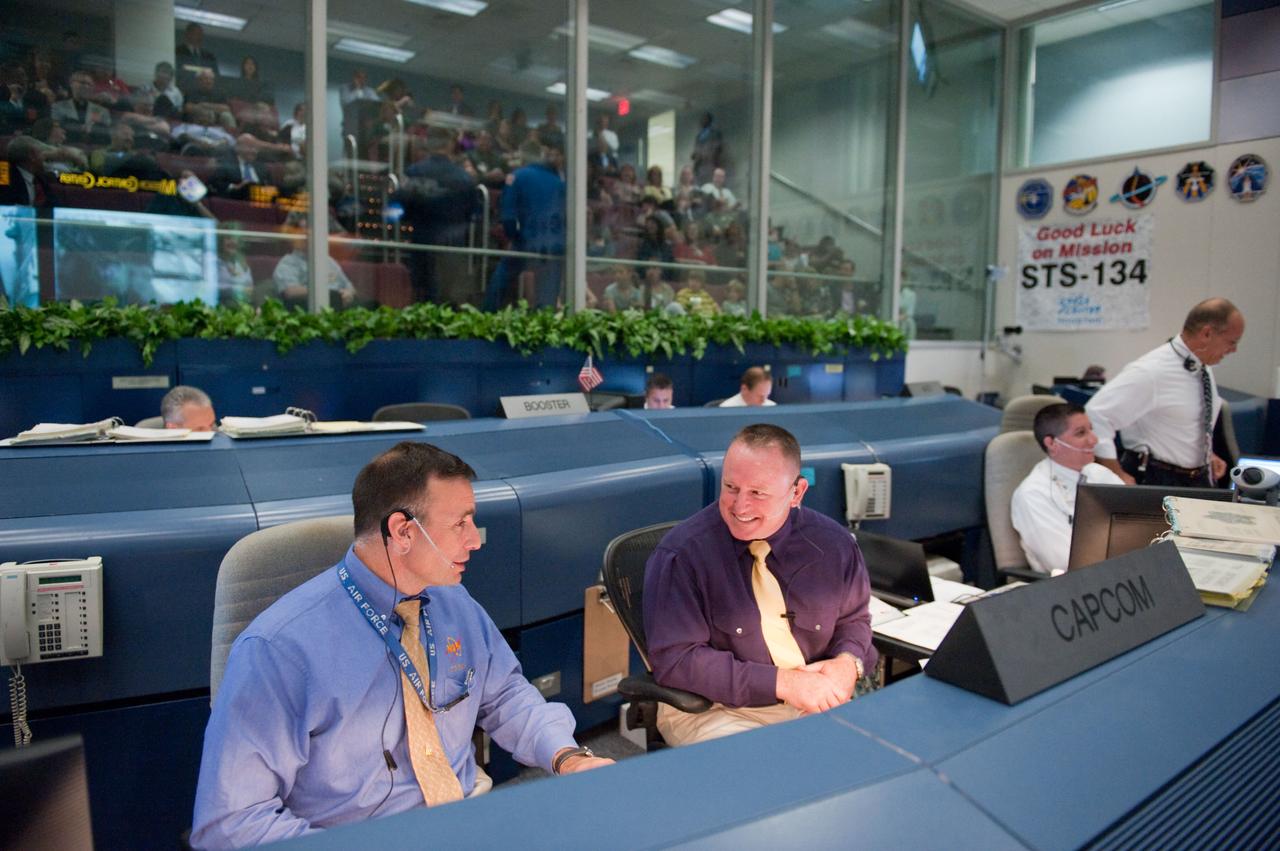 JSC2011-E-044250 (16 May 2011) --- NASA astronauts Lee Archambault (left) and Barry Wilmore, both STS-134 spacecraft communicators (CAPCOM), are pictured at their console in the space shuttle flight control room in the Mission Control Center at NASA's Johnson Space Center during launch countdown activities a few hundred miles away in Florida, site of space shuttle Endeavour's STS-134 launch. Liftoff was at 8:56 a.m. (EDT) on May 16, 2011, from Launch Pad 39A at NASA's Kennedy Space Center. Photo credit: NASA