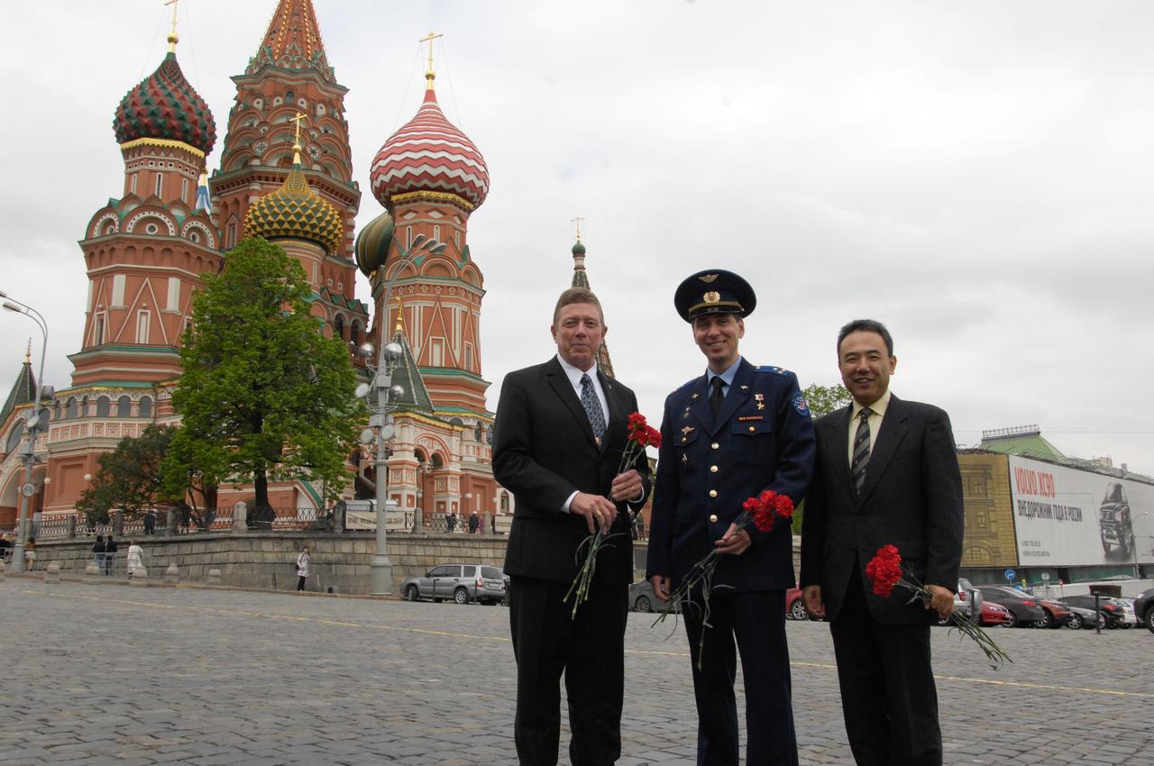 Expedition 28 Flight Engineer Mike Fossum of NASA (left), Soyuz Commander Sergei Volkov (center) and Flight Engineer Satoshi Furukawa of the Japan Aerospace Exploration Agency pose for pictures in front of the famed St. Basil’s Cathedral in Red Square in Moscow May 16, 2011 as they conducted traditional activities in advance of their launch June 8 from the Baikonur Cosmodrome in Kazakhstan in the Soyuz TMA-02M spacecraft to the International Space Station. 