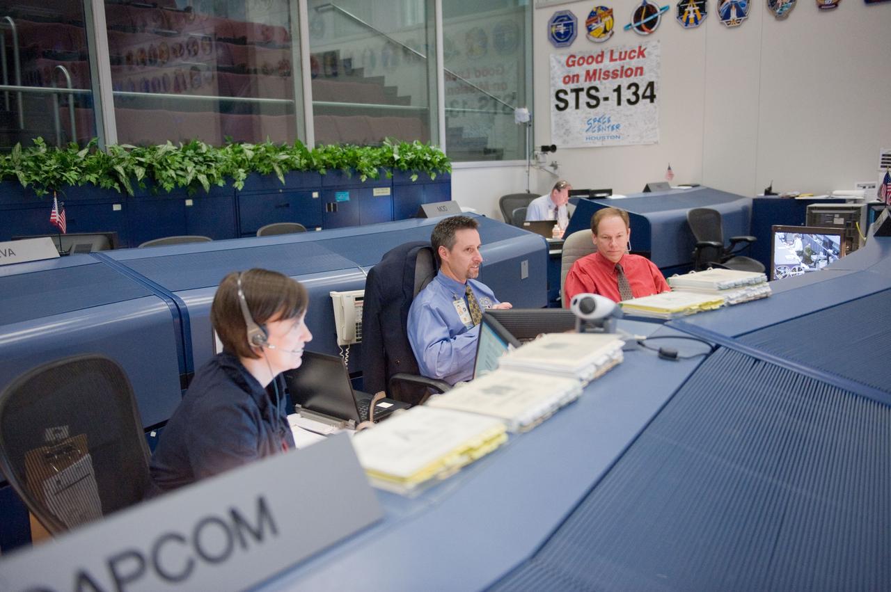 JSC2011-E-046798 (19 May 2011) --- NASA astronaut Megan McArthur, spacecraft communicator (CAPCOM); flight director Gary Horlacher (center) and John McCullough, chief of the Flight Director Office, are pictured in the space shuttle flight control room in the Mission Control Center at NASA's Johnson Space Center during STS-134 flight day four activities. Photo credit: NASA