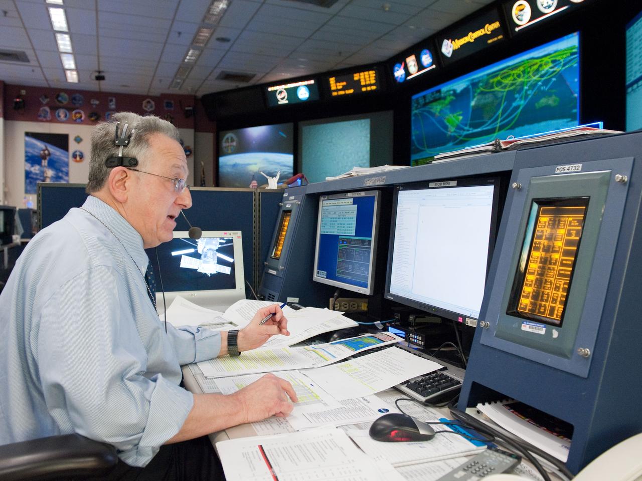 JSC2011-E-047750 (23 May 2011) --- Public Affairs Office (PAO) mission commentator Rob Navias is pictured at his console in the space station flight control room in the Mission Control Center at NASA's Johnson Space Center during STS-134 flight day eight activities. Photo credit: NASA