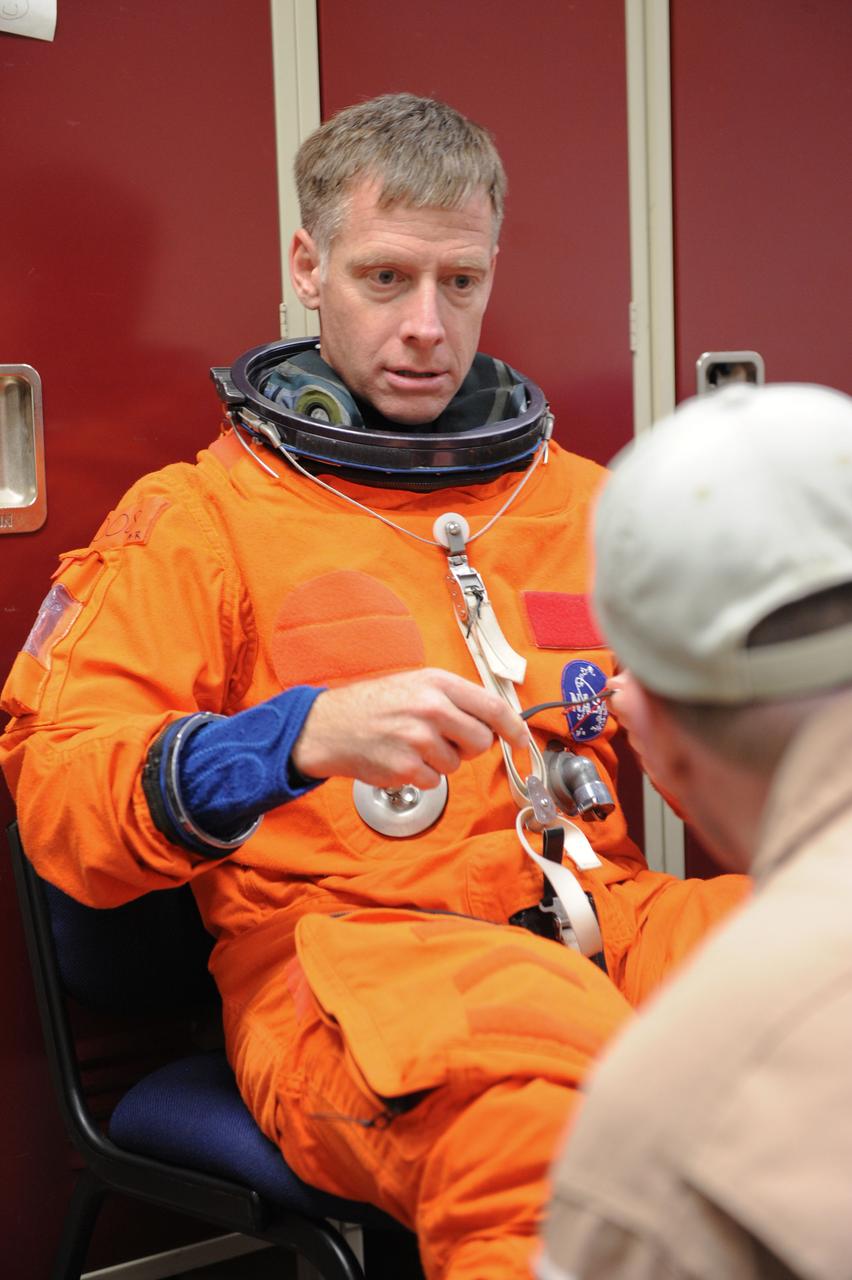 JSC2011-E-050002 (24 May 2011) --- NASA astronaut Chris Ferguson, STS-135 commander, attired in a training version of the shuttle launch and entry suit, prepares for an ingress/egress training session in a shuttle mock-up (out of frame) in the Space Vehicle Mock-up Facility at NASA's Johnson Space Center. Photo credit: NASA