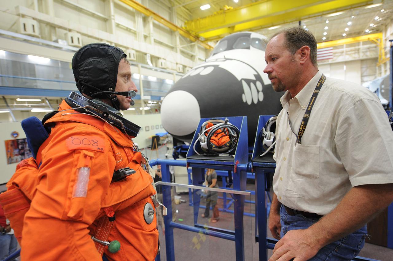 JSC2011-E-050013 (24 May 2011) --- NASA astronaut Chris Ferguson, STS-135 commander, attired in a training version of the shuttle launch and entry suit, participates in an ingress/egress training session in the Space Vehicle Mock-up Facility at NASA's Johnson Space Center. Drew Billingsley assisted Ferguson. Photo credit: NASA