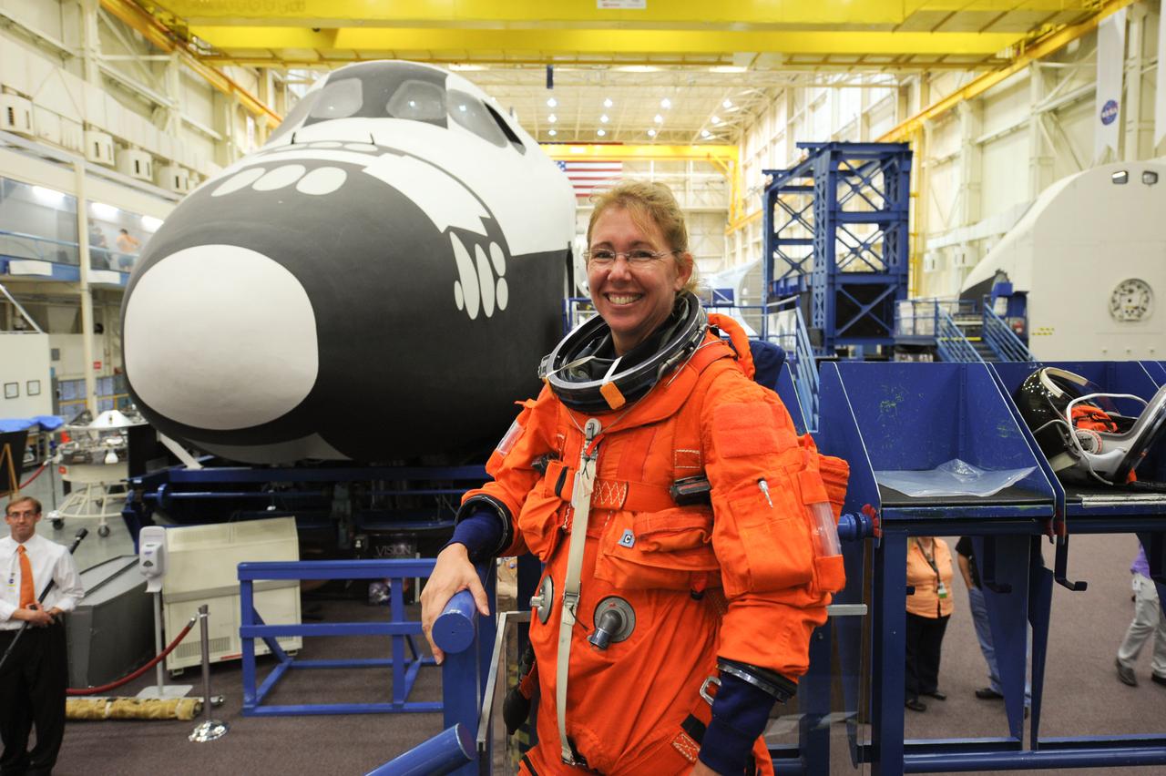 JSC2011-E-050025 (24 May 2011) --- NASA astronaut Sandy Magnus, STS-135 mission specialist, attired in a training version of the shuttle launch and entry suit, is pictured during an ingress/egress training session in the Space Vehicle Mock-up Facility at NASA's Johnson Space Center. Photo credit: NASA