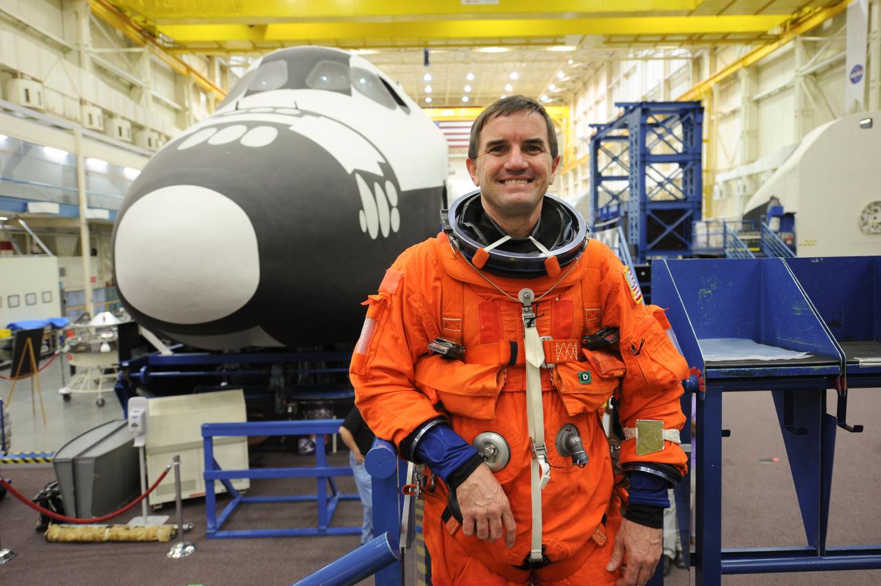 JSC2011-E-050041 (24 May 2011) --- NASA astronaut Rex Walheim, STS-135 mission specialist, attired in a training version of the shuttle launch and entry suit, is pictured during an ingress/egress training session in the Space Vehicle Mock-up Facility at NASA's Johnson Space Center. Photo credit: NASA