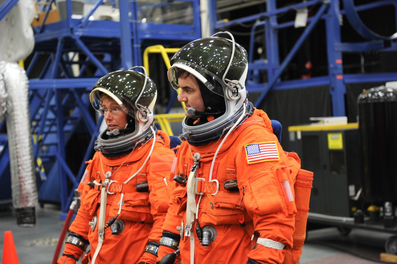 JSC2011-E-050066 (24 May 2011) --- NASA astronauts Sandy Magnus and Rex Walheim, both STS-135 mission specialists, attired in training versions of the shuttle launch and entry suit, participate in an ingress/egress training session in the Space Vehicle Mock-up Facility at NASA's Johnson Space Center. Photo credit: NASA