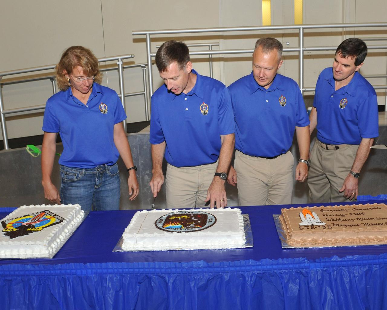 JSC2011-E-052055 (2 June 2011) --- STS-135 crew members are pictured during a cake-cutting ceremony in the Jake Garn Simulation and Training Facility at NASA's Johnson Space Center. Pictured are NASA astronauts Chris Ferguson (center left), commander; Doug Hurley (center right), pilot; Rex Walheim and Sandy Magnus, both mission specialists. Photo credit: NASA