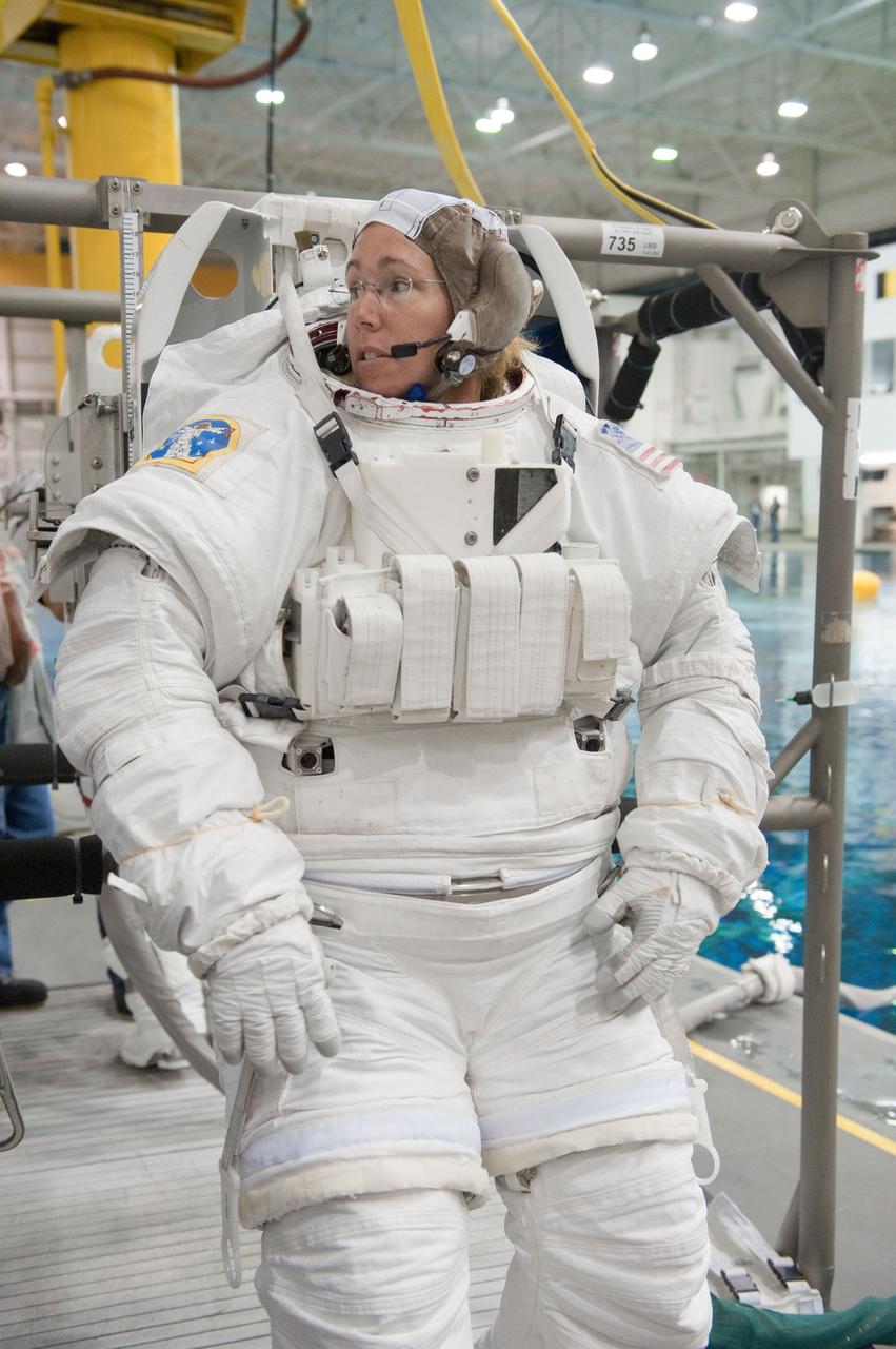 JSC2011-E-054048 (13 June 2011) --- NASA astronaut Sandy Magnus, STS-135 mission specialist, attired in a training version of her Extravehicular Mobility Unit (EMU) spacesuit, awaits the start of a spacewalk training session in the waters of the Neutral Buoyancy Laboratory (NBL) near NASA's Johnson Space Center. Photo credit: NASA
