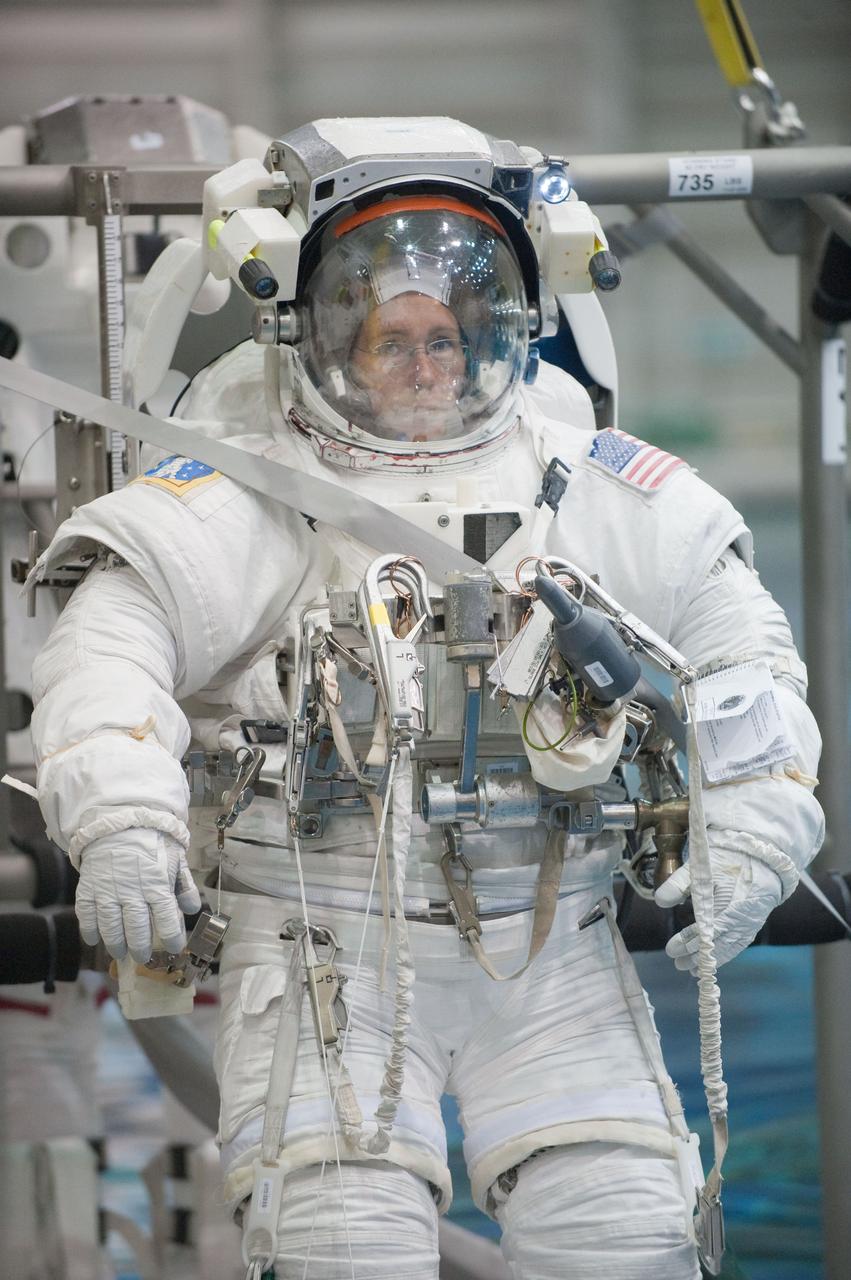 Photograph final space shuttle crew training session in the NBL with STS-135 Mission Specialists Sandy Magnus & Rex Walheim. STS-135 Commander Chris Ferguson serves as Intravehicular suit-up lead, Pilot Doug Hurley serves as robotic arm operator. Mission Specialists Sandy Magnus & Rex Walheim in the water.  Photo Date: June 13, 2011.  Location: NBL - Pool Topside.  Photographer: Robert Markowitz