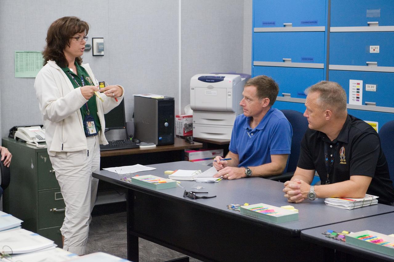 JSC2011-E-058623 (24 June 2011) --- NASA astronauts Chris Ferguson (seated left), STS-135 commander; and Doug Hurley, pilot, participate in a flight data file review in the Flight Operations Facility at NASA?s Johnson Space Center. Instructor Sandy Wayne assisted Ferguson and Hurley. Photo credit: NASA