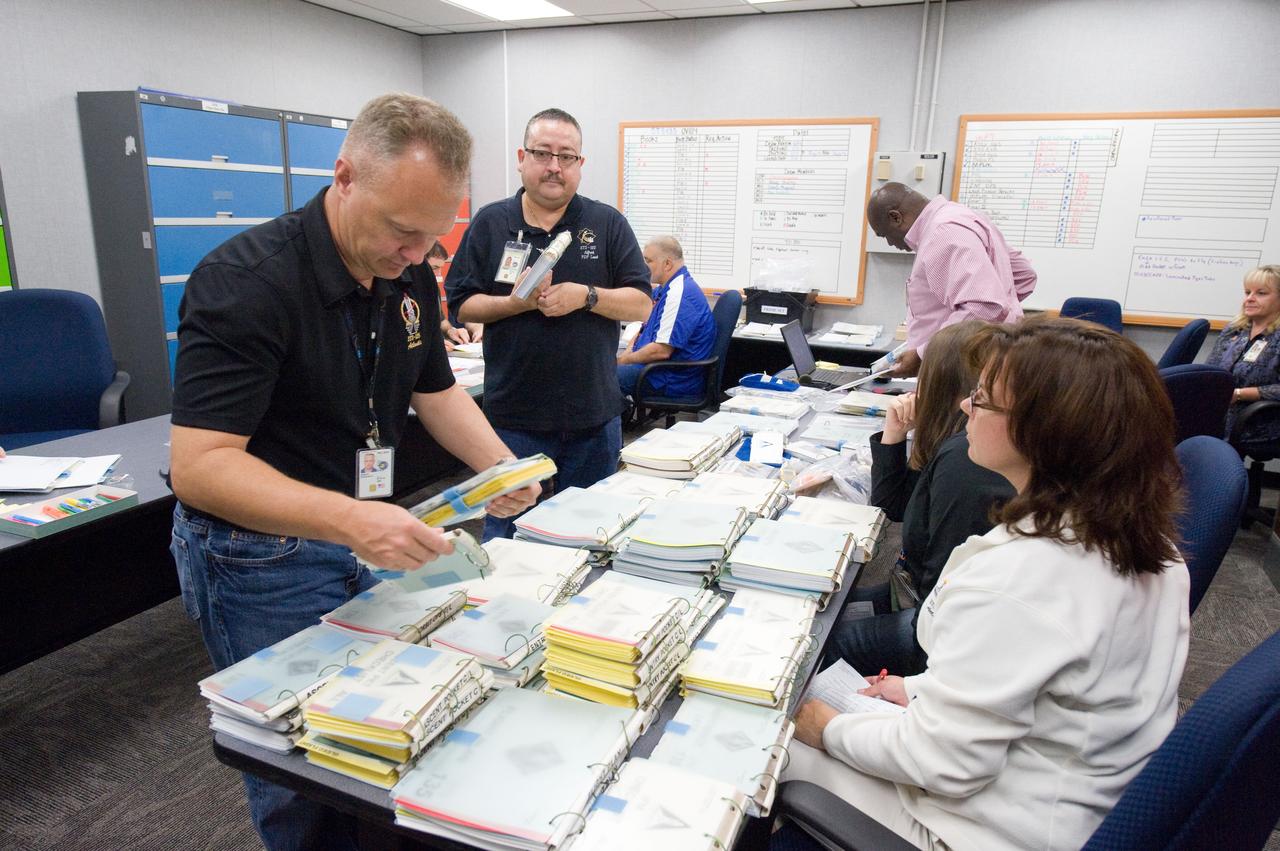 JSC2011-E-058633 (24 June 2011) --- NASA astronaut Doug Hurley (left foreground), STS-135 pilot, participates in a flight data file review in the Flight Operations Facility at NASA?s Johnson Space Center. Instructor Sandy Wayne assisted Hurley. Photo credit: NASA