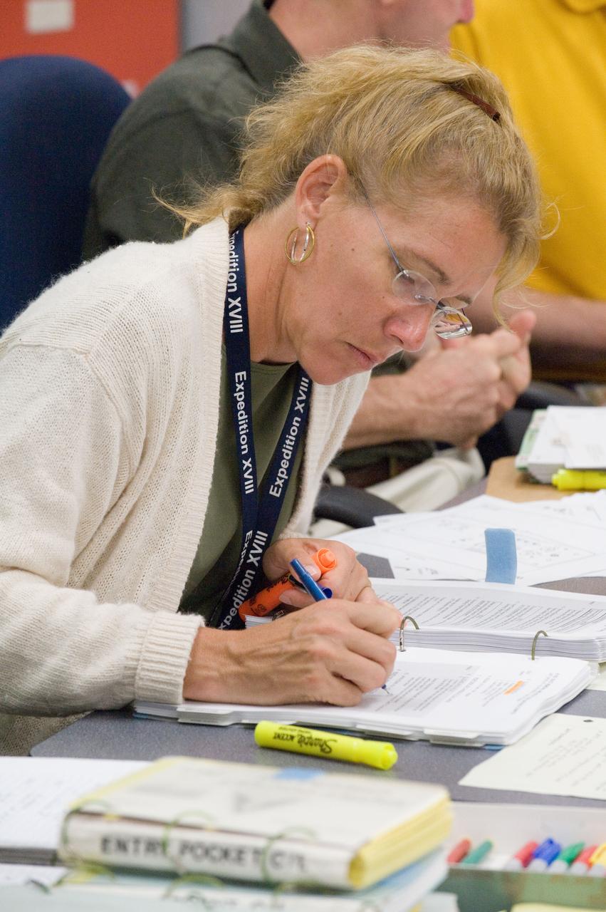 JSC2011-E-058647 (24 June 2011) --- NASA astronaut Sandy Magnus, STS-135 mission specialist, participates in a flight data file review in the Flight Operations Facility at NASA?s Johnson Space Center. Photo credit: NASA
