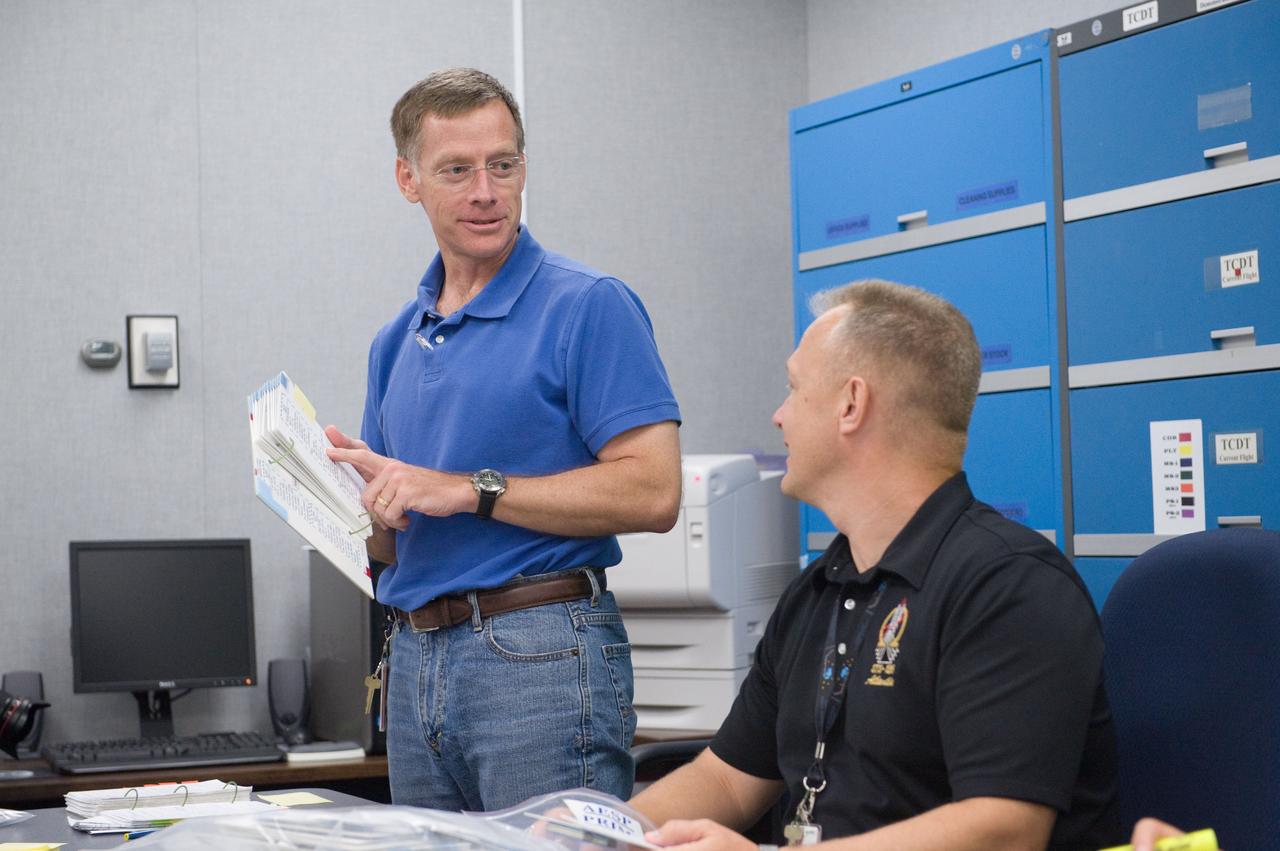 JSC2011-E-058668 (24 June 2011) --- NASA astronauts Chris Ferguson (left), STS-135 commander; and Doug Hurley, pilot, participate in a flight data file review in the Flight Operations Facility at NASA?s Johnson Space Center. Photo credit: NASA