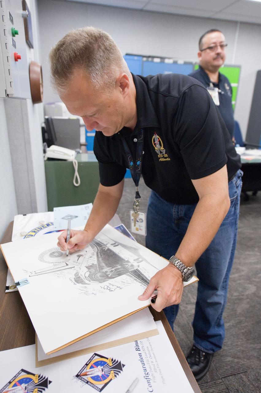 JSC2011-E-058681 (24 June 2011) --- NASA astronaut Doug Hurley, STS-135 pilot, participates in a flight data file review in the Flight Operations Facility at NASA?s Johnson Space Center. Photo credit: NASA