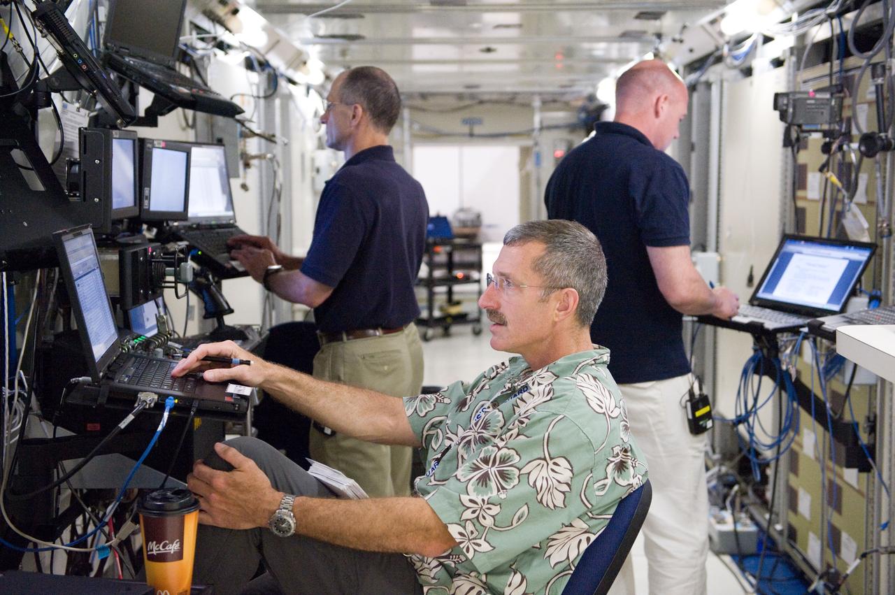 PHOTO DATE: 22 June 2011 LOCATION: Bldg. 5, Space Station Training Facility. SUBJECT: Expedition 29/30 crew training during Electrical Power System Major Case training event. Astronauts Dan Burbank, Don Pettit and Andre Kuipers working together in mockup. PHOTOGRAPHER: Mark Sowa