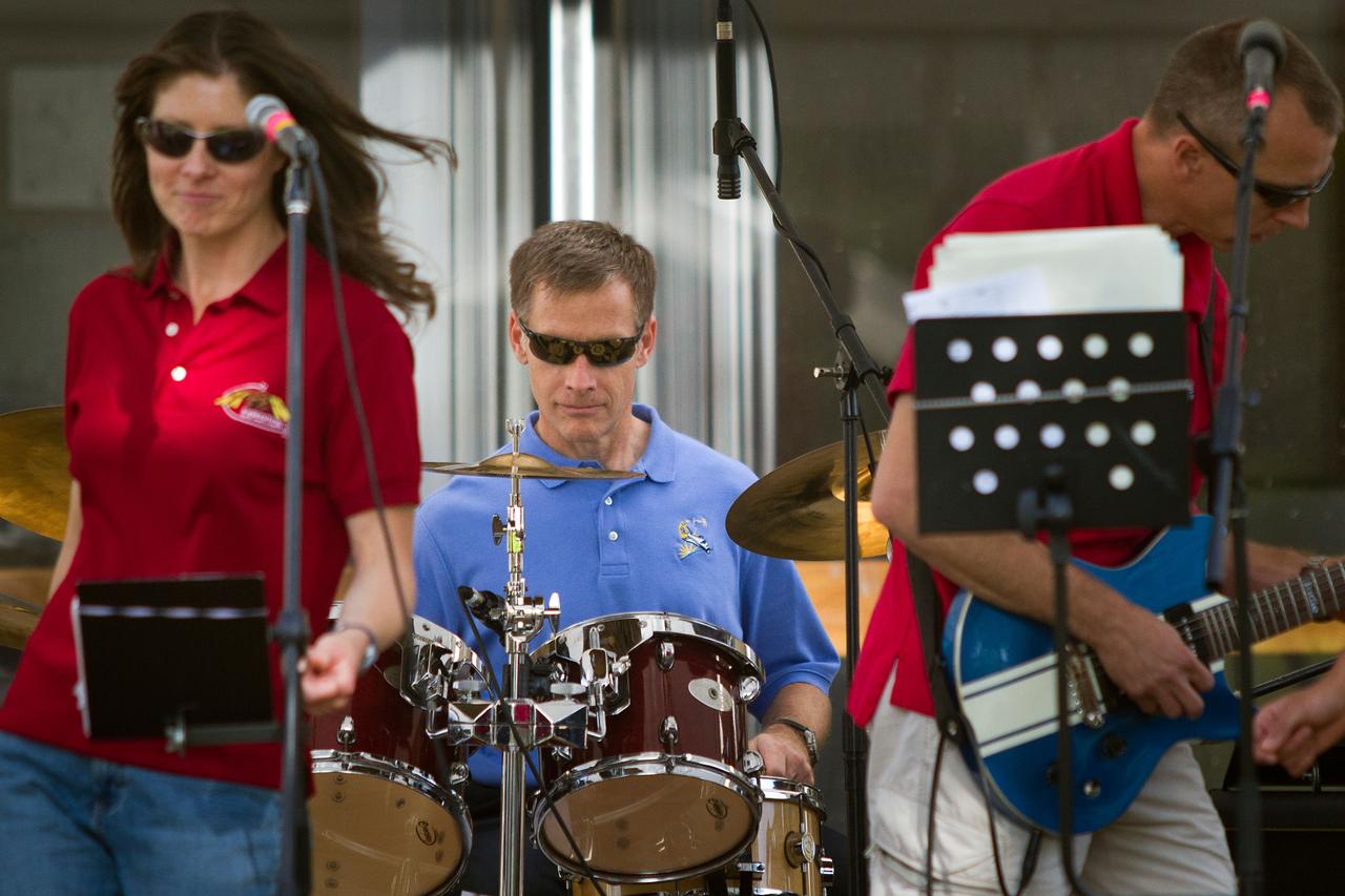 JSC2011-E-059375 (4 May 2011) --- NASA astronaut Chris Ferguson, STS-135 commander, plays the drums with the all-astronaut band known as Max Q as the group performs on Innovation Day at NASA?s Johnson Space Center in Houston May 4, 2011. Vocalist Tracy Caldwell Dyson is at left.  Guitarist Drew Feustel is at right.  Photo credit: NASA Photo/Houston Chronicle, Smiley N. Pool