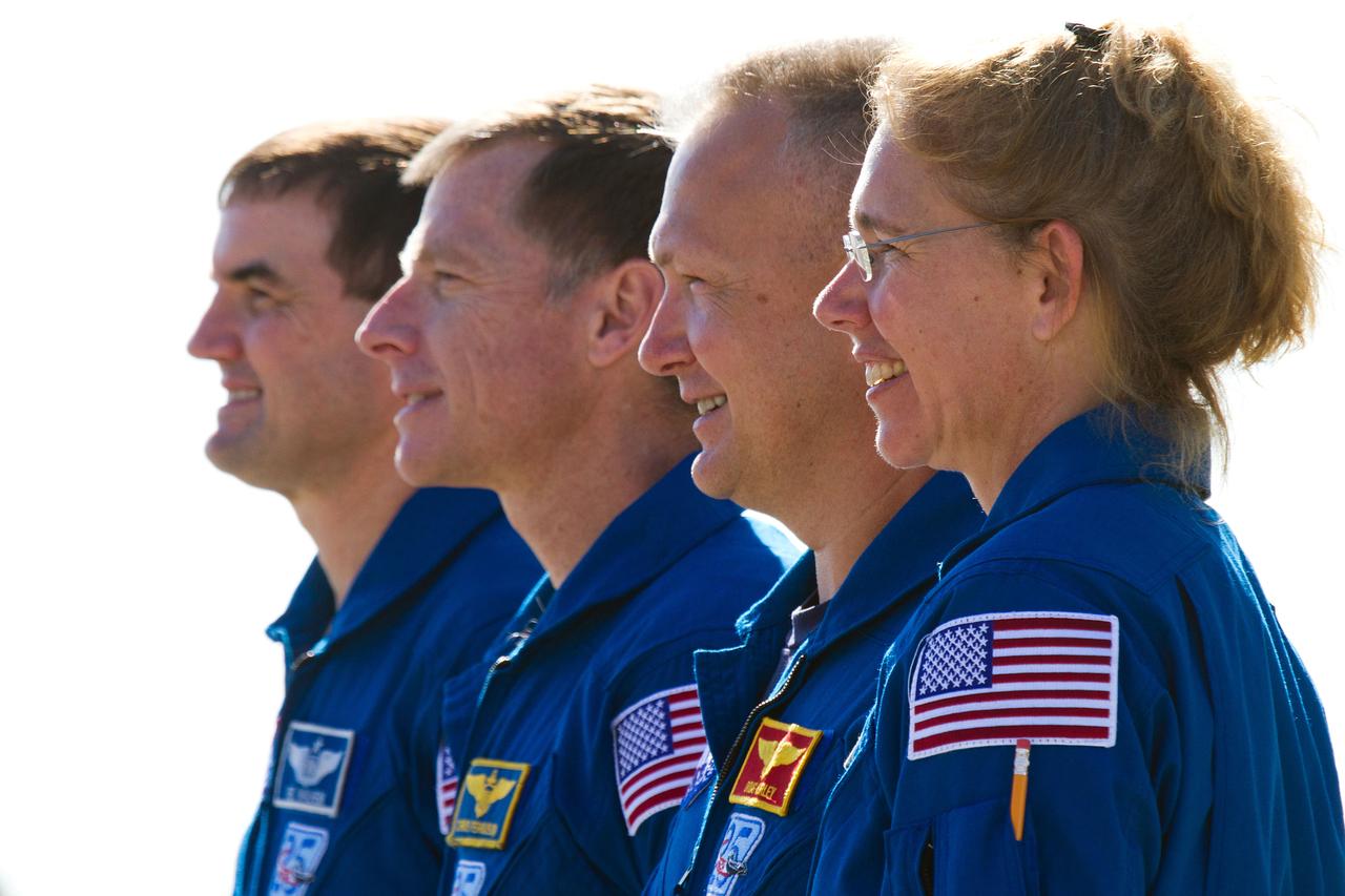 JSC2011-E-059418 (17 May 2011) --- The crew of STS-135, from right, Sandy Magnus, Doug Hurley, Chris Ferguson and Rex Walheim pose for a group photo as the space shuttle Atlantis (out of frame) is moved from the Orbiter Processing facility to the Vehicle Assembly Building at NASA?s Kennedy Space Center in Florida on May 17, 2011. The move, known as rollover, is a milestone in the preparation for launch as the orbiter leaves its processing hangar to be prepped for its final flight. Photo credit: NASA Photo/Houston Chronicle, Smiley N. Pool