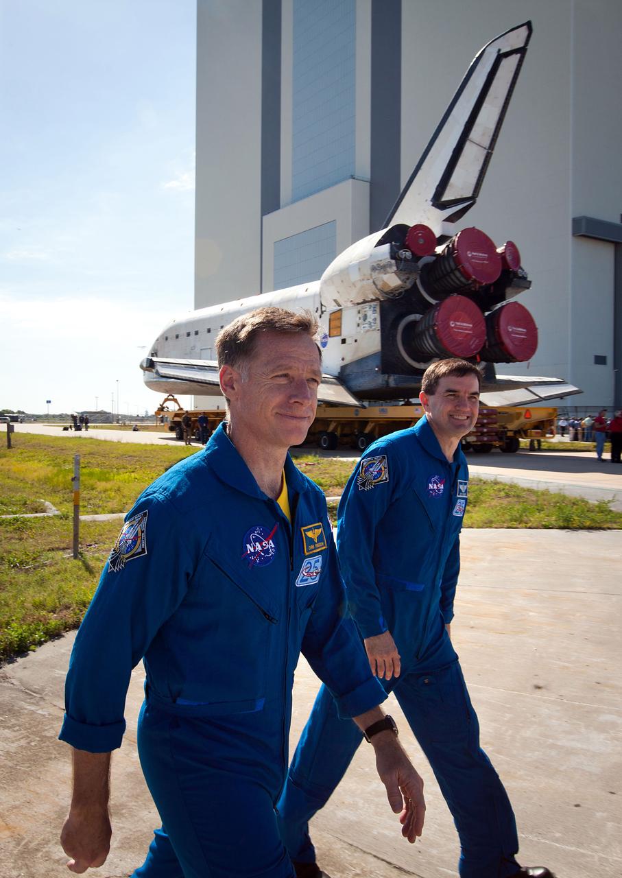 JSC2011-E-059420 (17 May 2011) --- NASA astronauts Chris Ferguson, left, and Rex Walheim walk past the space shuttle Atlantis as it is moved from the Orbiter Processing Facility to the Vehicle Assembly Building at NASA?s Kennedy Space Center on May 17, 2011. The move, known as rollover, is a milestone in the preparation for launch as the orbiter leaves its processing hangar to be prepped for its final flight. Photo credit: NASA Photo/Houston Chronicle, Smiley N. Pool