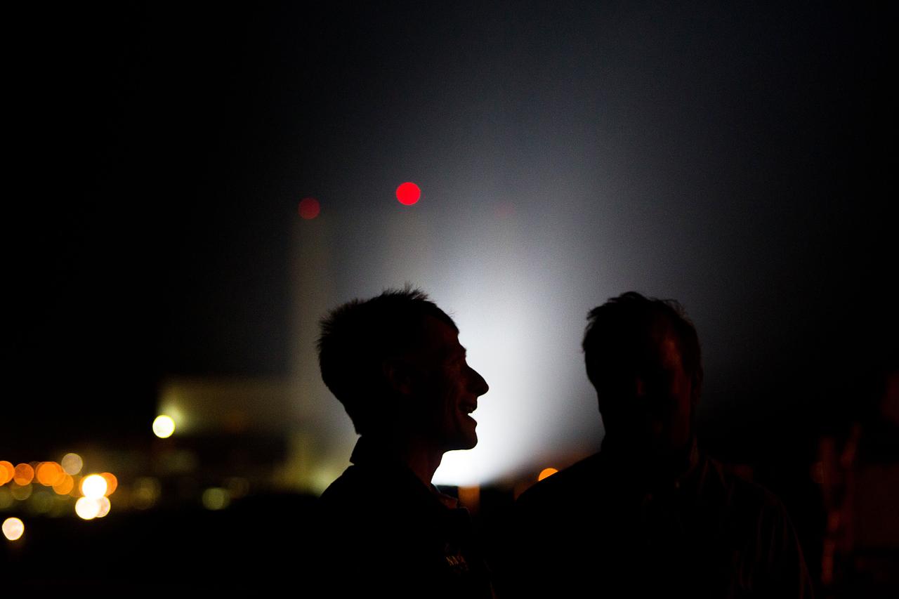 JSC2011-E-059478 (31 May 2011) --- NASA astronaut Chris Ferguson, STS-135 commander, is seen in silhouette against the Vehicle Assembly Building as the space shuttle Atlantis moves to Launch Pad 39A during rollout at NASA?s Kennedy Space Center in Florida May 31, 2011.  Photo credit: NASA Photo/Houston Chronicle, Smiley N. Pool