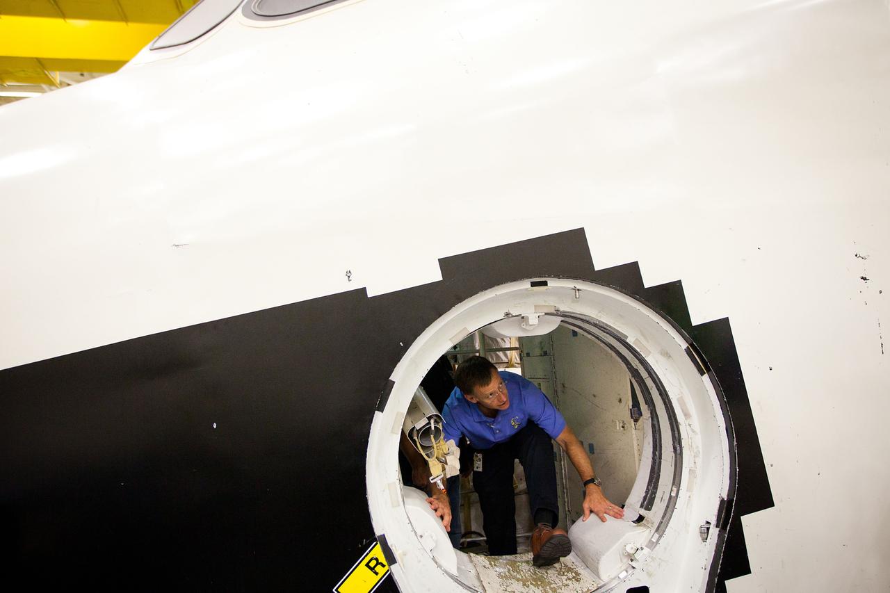 JSC2011-E-060138 (29 June 2011) --- NASA astronaut Chris Ferguson crawls out of the Crew Compartment Trainer (CCT-2) as the crew of STS-135 trains at NASA?s Johnson Space Center June 29, 2011. The training marked the crew's final scheduled session in the Space Vehicle Mock-up Facility. Photo credit: NASA Photo/Houston Chronicle, Smiley N. Pool
