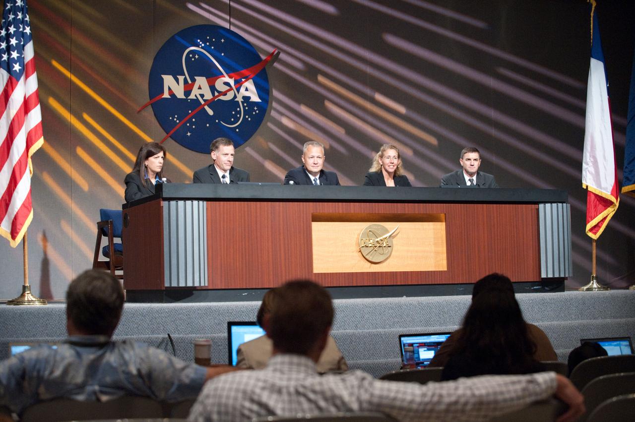 JSC2011-E-060457 (30 June 2011) --- The STS-135 crew members along with Public Affairs Office moderator Nicole Cloutier (left) are pictured during a preflight press conference at NASA's Johnson Space Center. From the second left are NASA astronauts Chris Ferguson, commander; Doug Hurley, pilot; Sandy Magnus and Rex Walheim, both mission specialists. News media representatives are visible in the foreground. Photo credit: NASA
