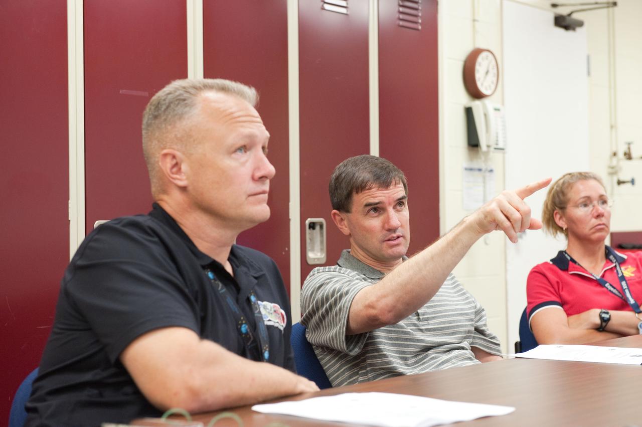JSC2011-E-060746 (29 June 2011) --- NASA astronauts Doug Hurley (left), STS-135 pilot; Rex Walheim and Sandy Magnus, both mission specialists, are pictured during a training session in the Space Vehicle Mock-up Facility at NASA's Johnson Space Center. Photo credit: NASA