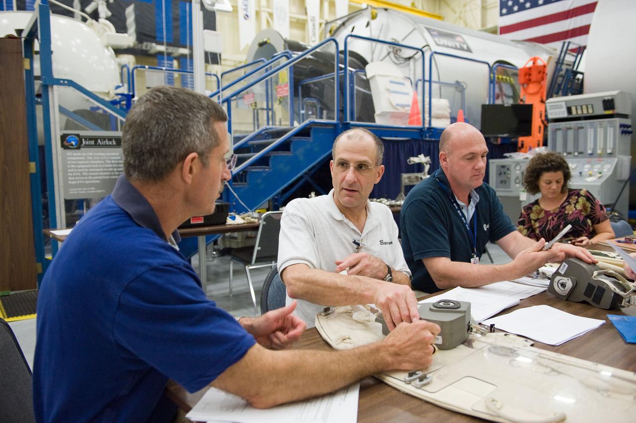 PHOTO DATE: 06-23-11 LOCATION:  Bldg 9nw, ISS Mockups SUBJECT: Expedition 29 crew members, Dan Burbank, Don Pettit and Andre Kuiper during ISS EVA Tool Configuration with instructor Sandra Moore WORK ORDER:  2011-1764 PHOTOGRAPHER:  James Blair 