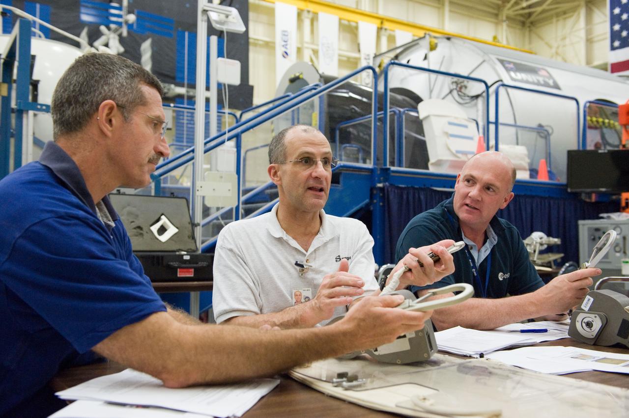 PHOTO DATE: 06-23-11 LOCATION:  Bldg 9nw, ISS Mockups SUBJECT: Expedition 29 crew members, Dan Burbank, Don Pettit and Andre Kuiper during ISS EVA Tool Configuration with instructor Sandra Moore WORK ORDER:  2011-1764 PHOTOGRAPHER:  James Blair 